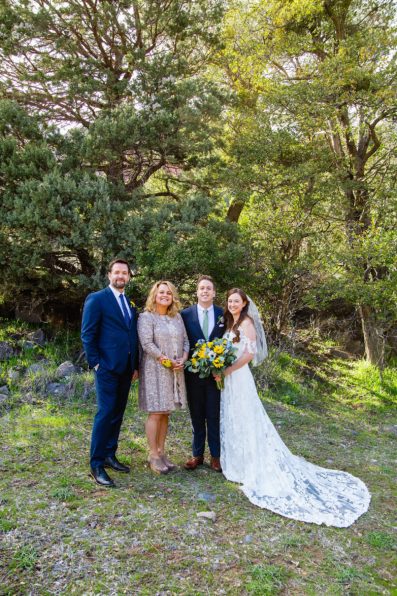 Bride and groom take photos with their family by Sedona elopement photographer PMA Photography.