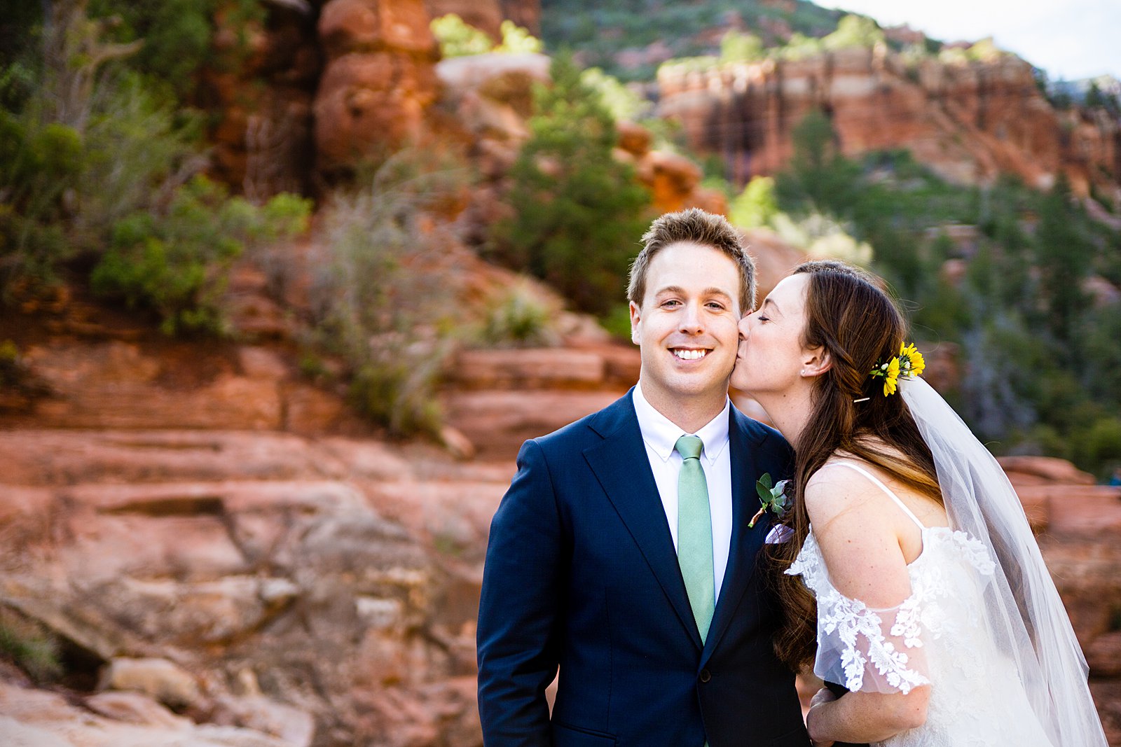 Bride and Groom share a kiss during their Slide Rock elopement by Arizona elopement photographer PMA Photography.