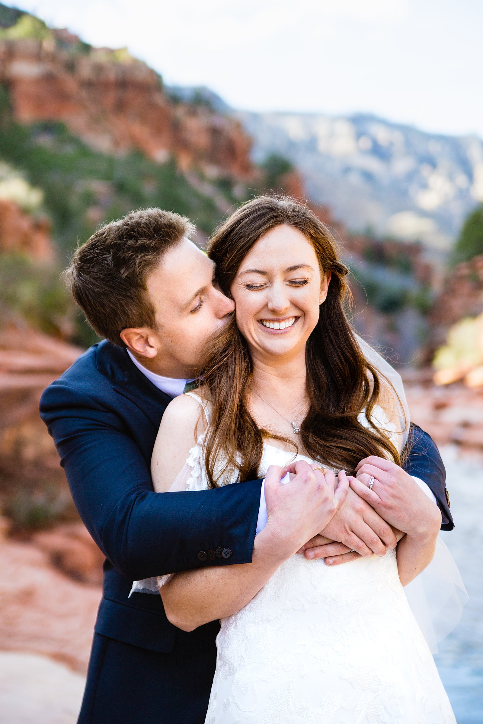 Bride and Groom laughing together during their Slide Rock elopement by Arizona elopement photographer PMA Photography.