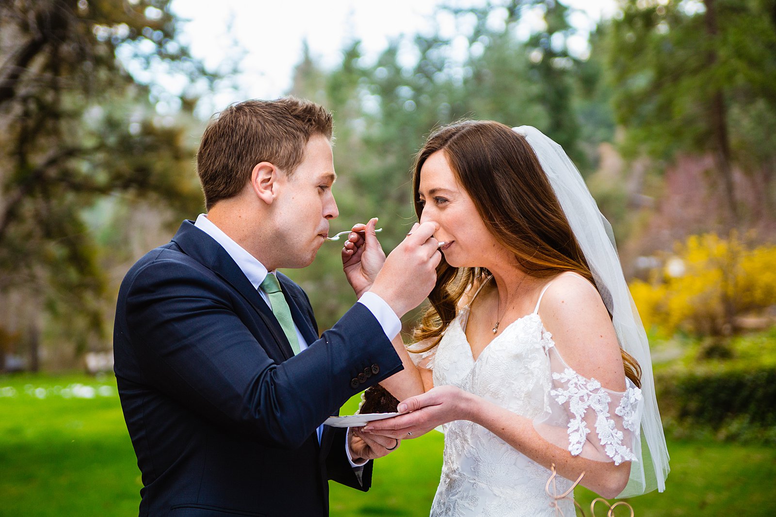 Bride and Groom share wedding cake at their Sedona elopement by Arizona elopement photographer PMA Photography.