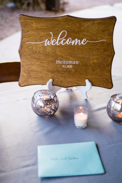 Custom wooden welcome sign at a wedding ceremony by PMA Photography.