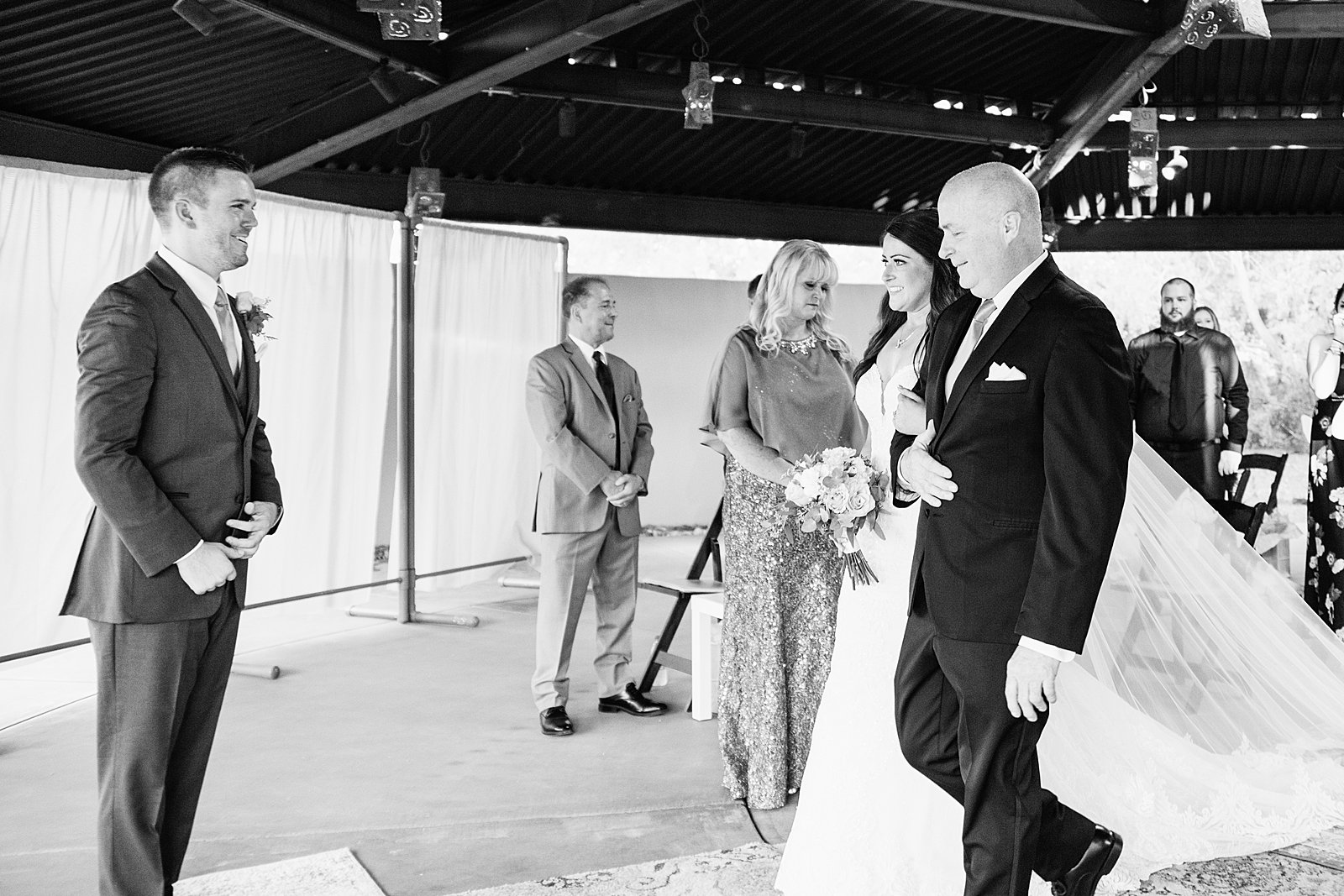 Bride walking down aisle during Desert Botanical Gardens wedding ceremony by Phoenix wedding photographer PMA Photography.