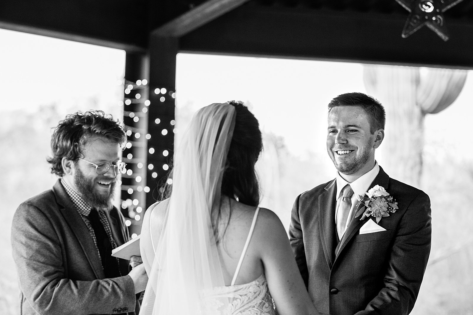 Groom looking at his bride during their wedding ceremony at Desert Botanical Gardens by Phoenix wedding photographer PMA Photography.