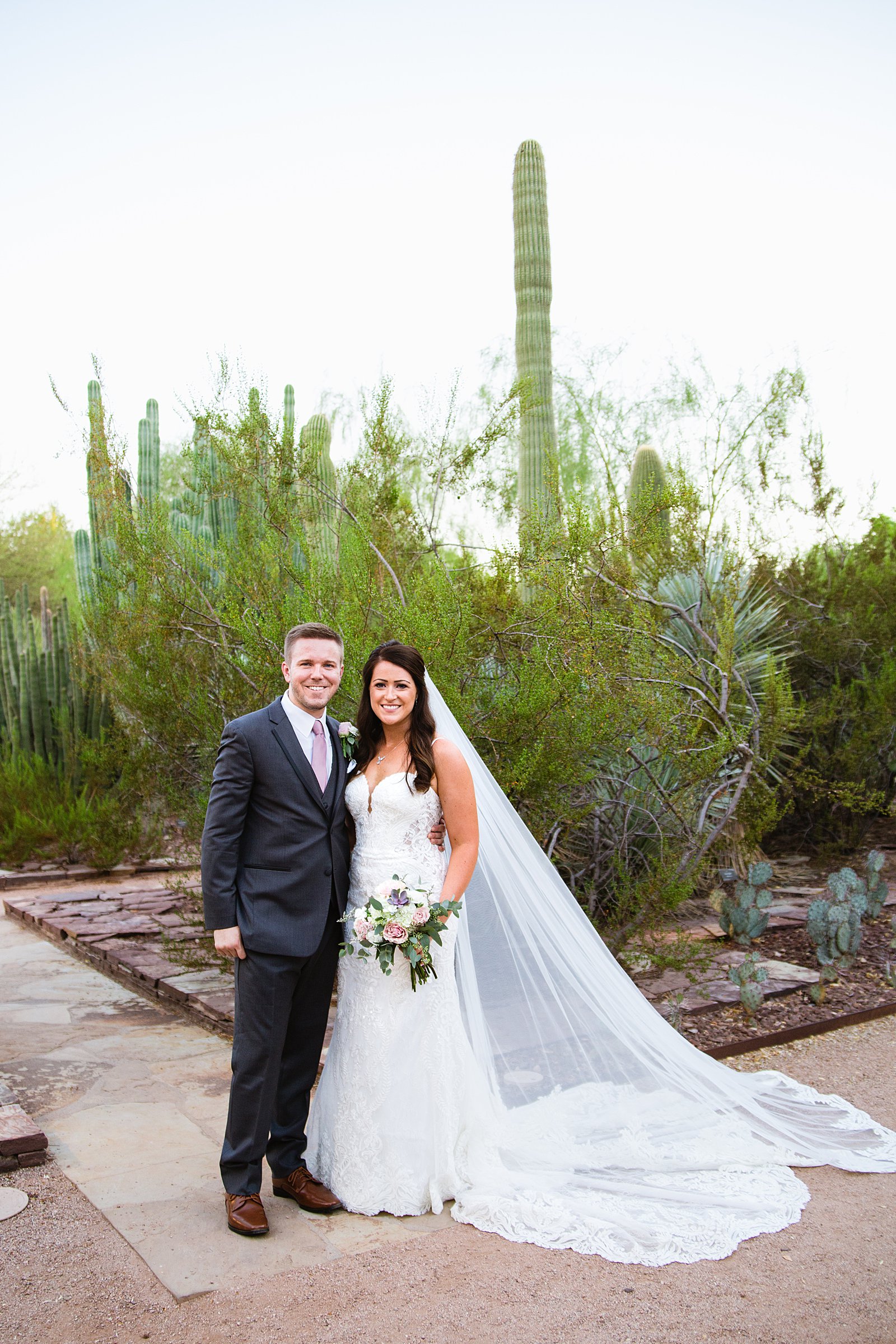 Bride and Groom pose during their Desert Botanical Gardens wedding by Arizona wedding photographer PMA Photography.