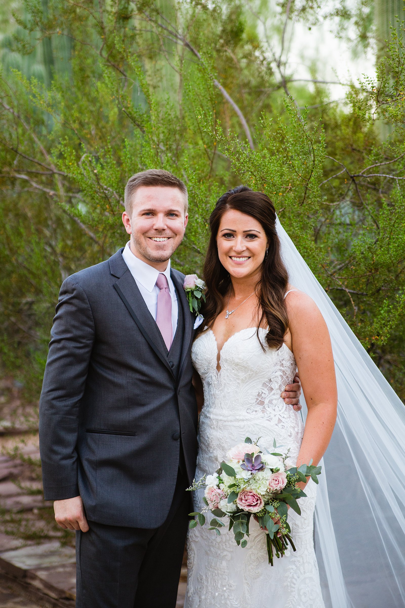 Bride and Groom pose during their Desert Botanical Gardens wedding by Arizona wedding photographer PMA Photography.