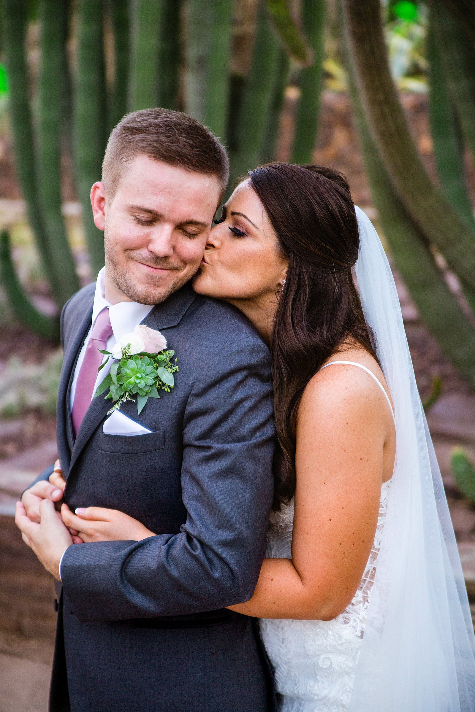 Bride and Groom share a kiss during their Desert Botanical Gardens wedding by Phoenix wedding photographer PMA Photography.