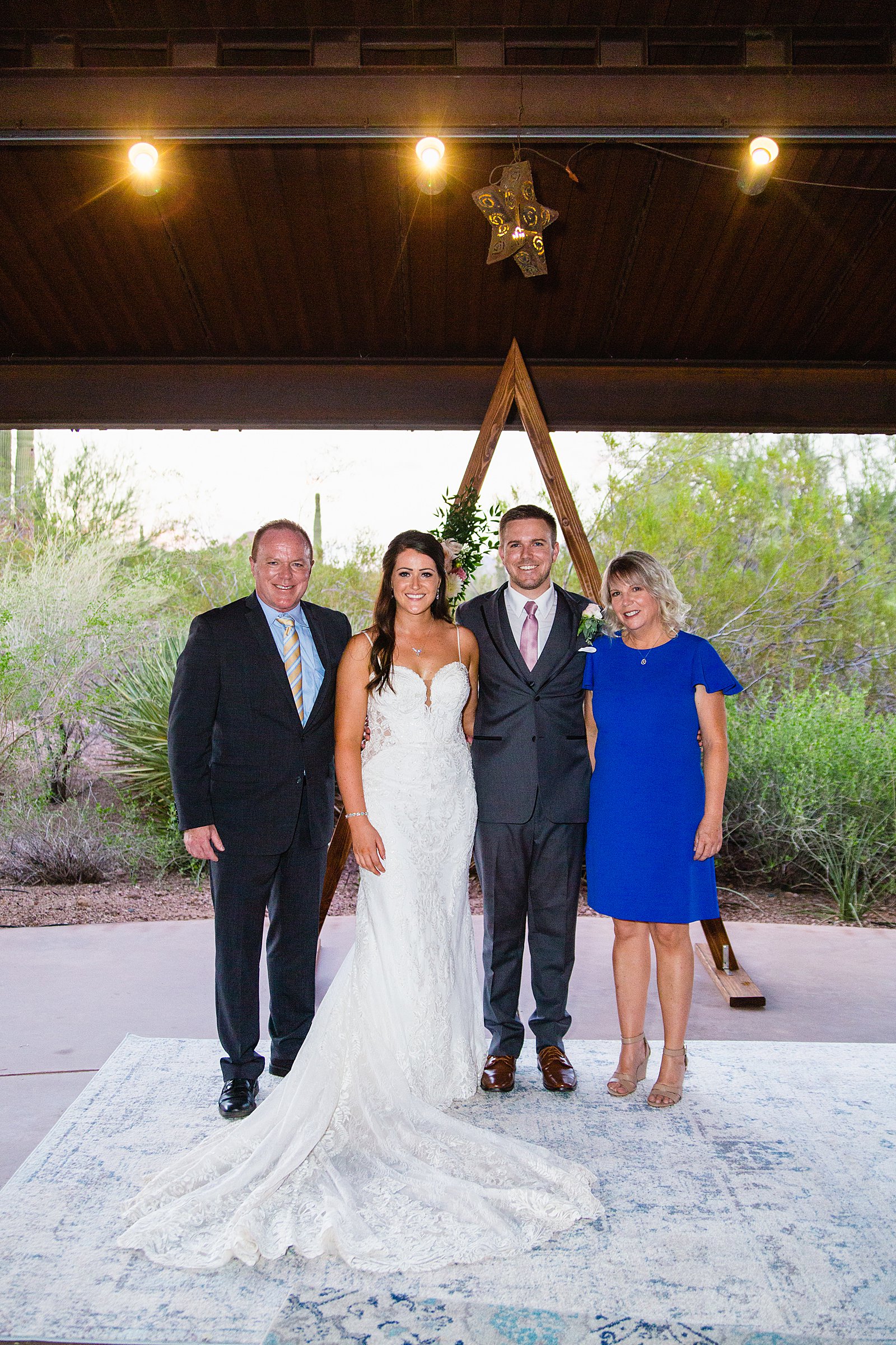 Bride and groom pose with their close family members at their Desert Botanical Garden's wedding by Phoenix wedding photographer PMA Photography.