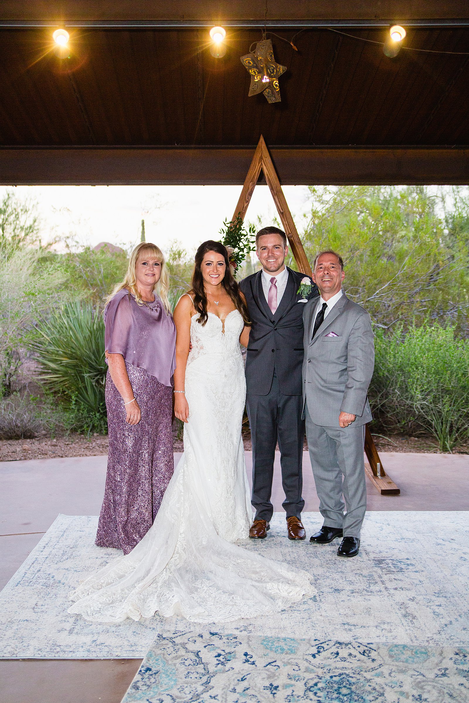 Bride and groom pose with their close family members at their Desert Botanical Garden's wedding by Phoenix wedding photographer PMA Photography.