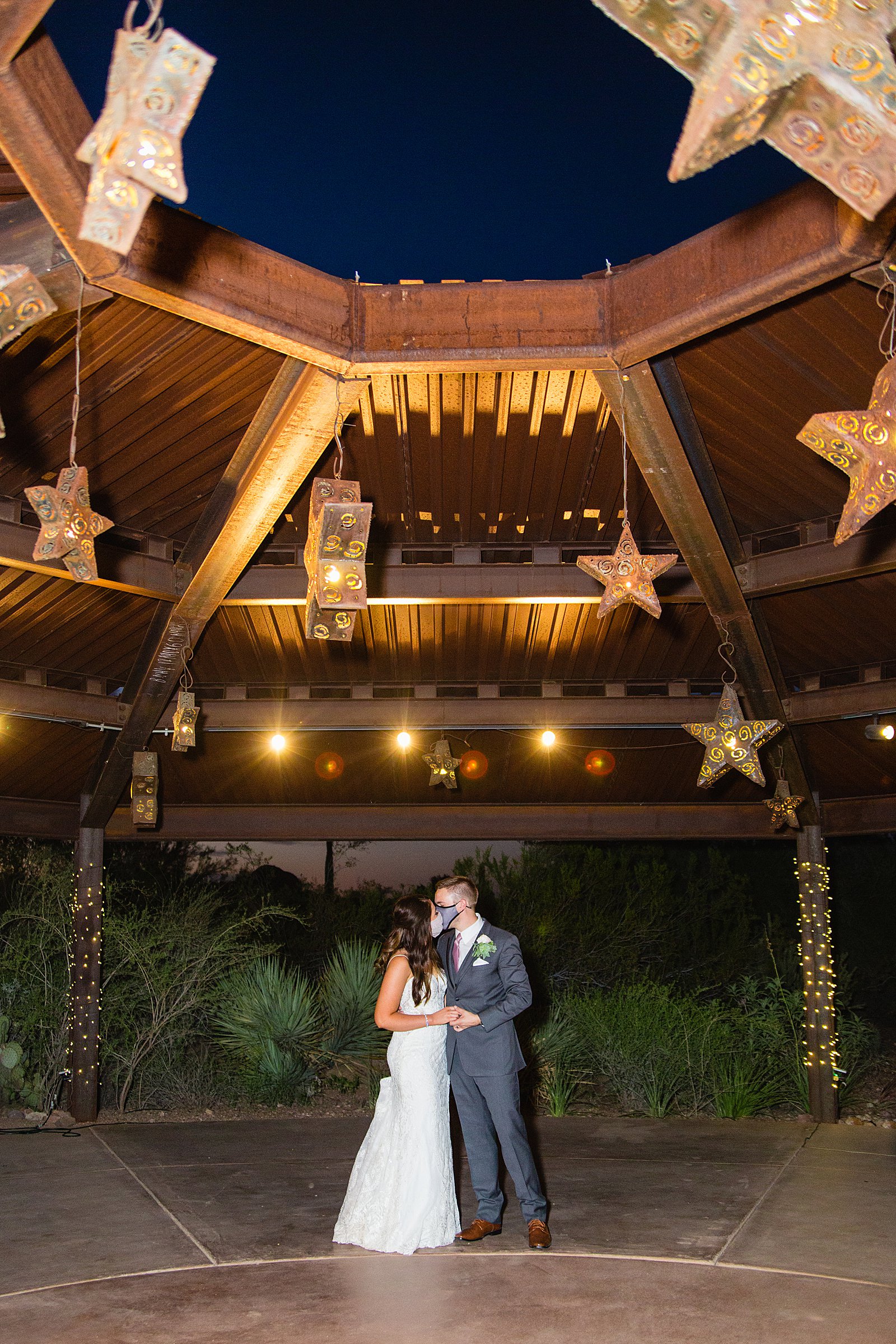 Bride and groom pose with masks during their corona micro-wedding at Desert Botanical Gardens by Phoenix wedding photographer PMA Photography.
