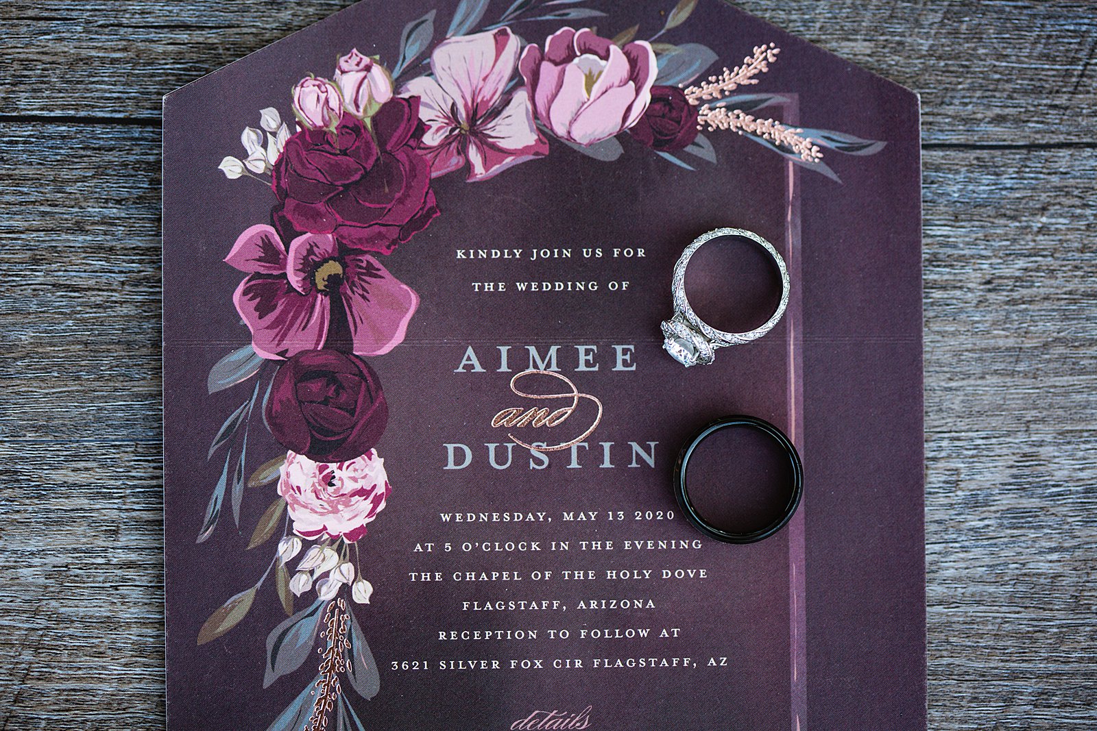 Purple and Maroon floral wedding invitation and wedding rings by PMA Photography.