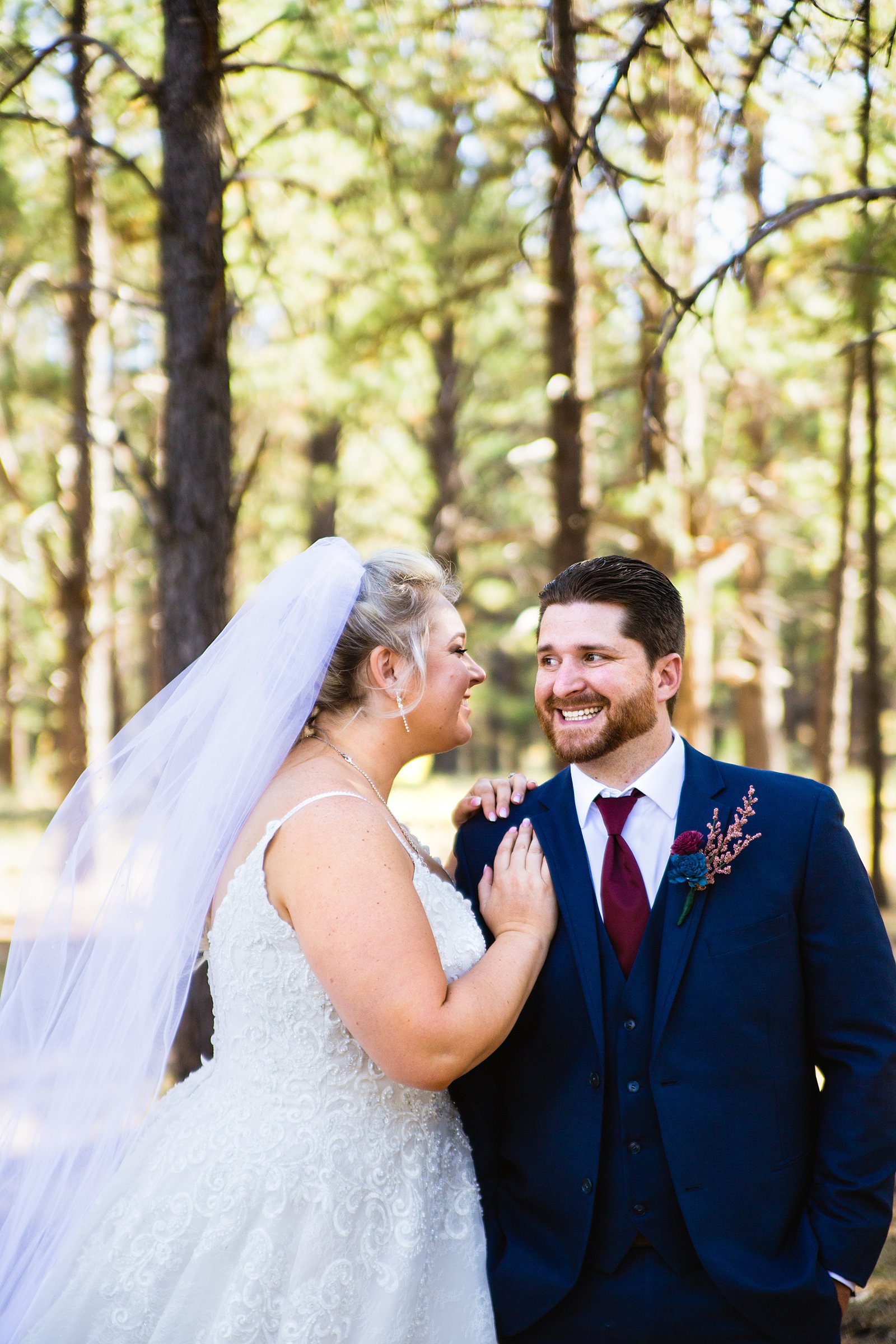 Bride and Groom laughing together during their Chapel of the Holy Dove wedding by Flagstaff wedding photographer PMA Photography.