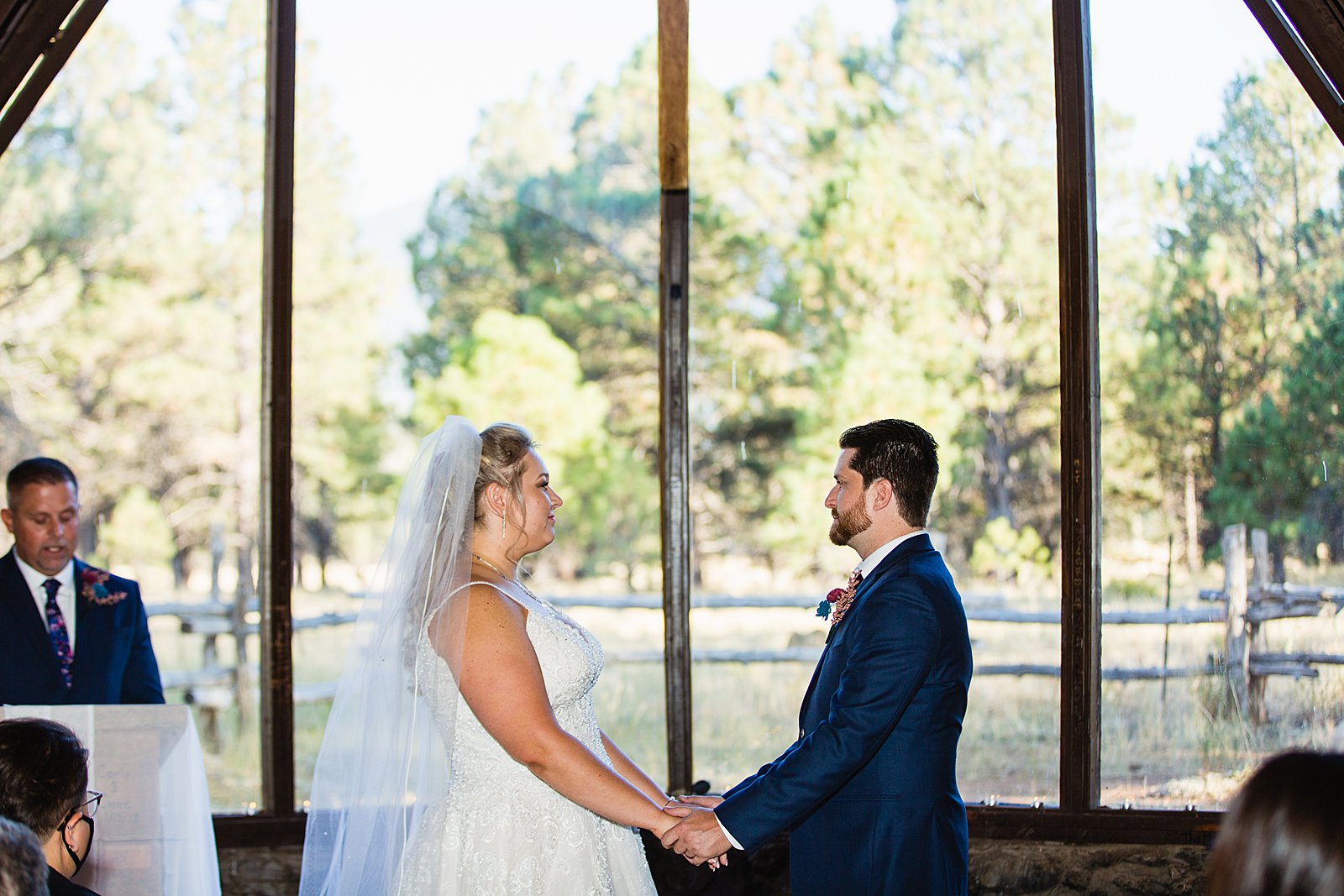Bride and Groom togethering during Chapel of the Holy Dove wedding ceremony by Flagstaff wedding photographer PMA Photography.