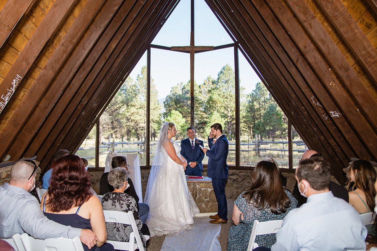 Groom reading his vows to the groom during a Chapel of the Holy Dove wedding ceremony by Flagstaff wedding photographer PMA Photography.