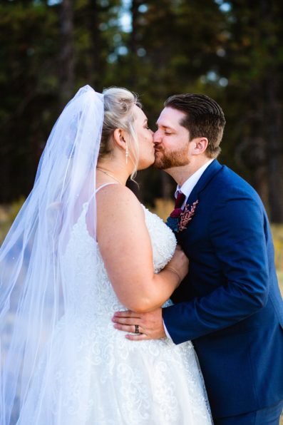 Bride and Groom share a kiss during their Chapel of the Holy Dove wedding by Arizona wedding photographer PMA Photography.