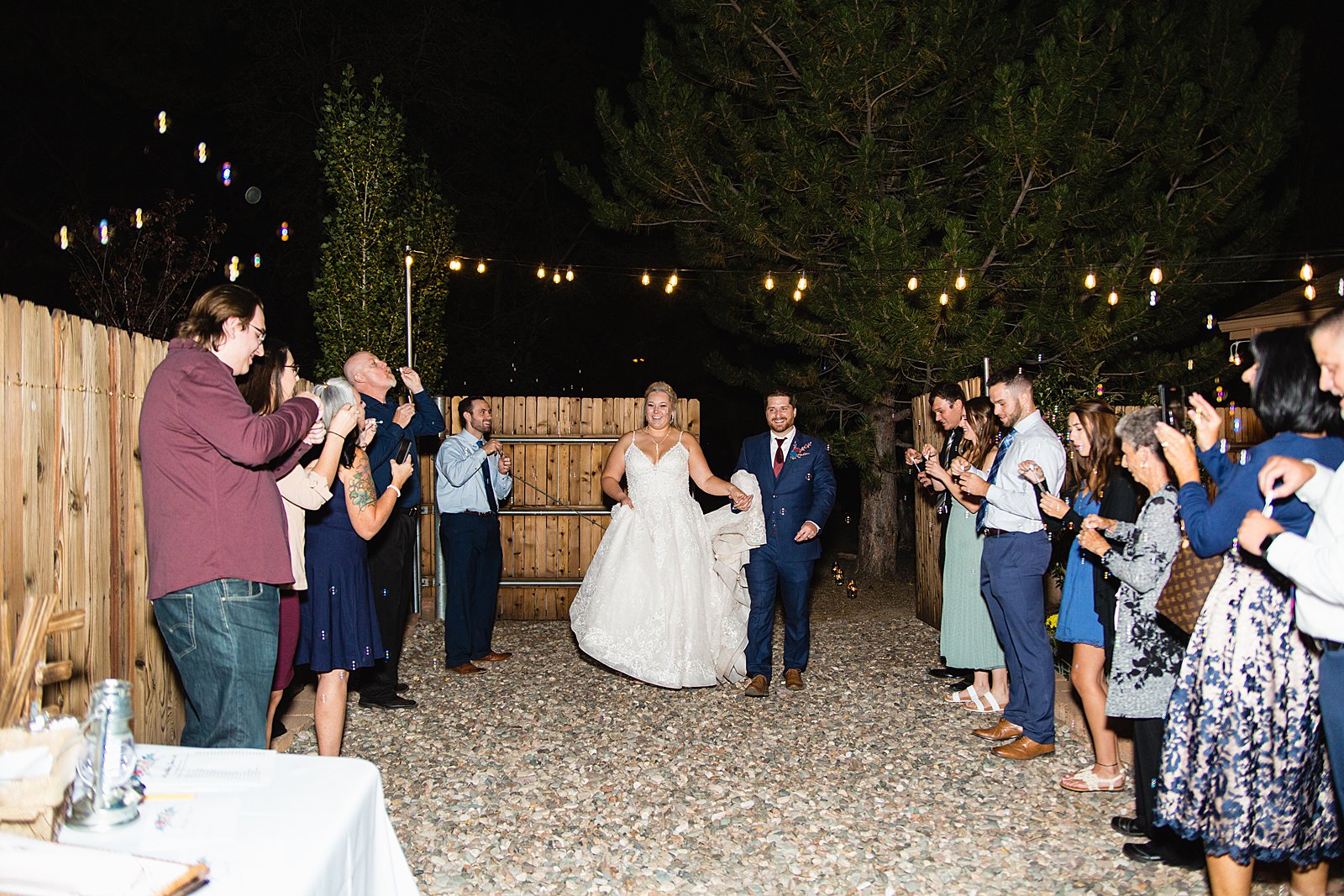 Bride and groom's grand entrance at their backyard wedding reception by Arizona wedding photographer PMA Photography.