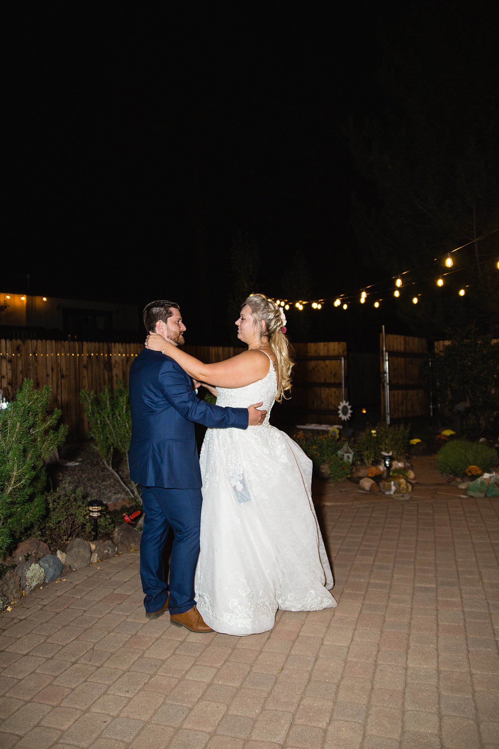 Bride and Groom sharing first dance at their backyard wedding reception by Arizona wedding photographer PMA Photography.