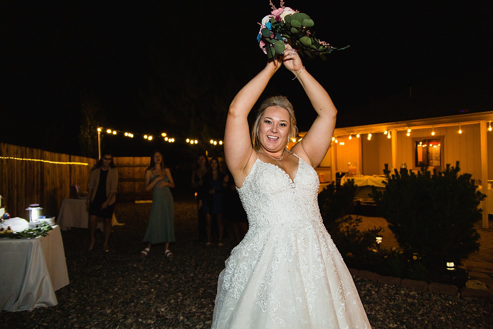 Bouquet toss at backyard wedding reception by Flagstaff wedding photographer PMA Photography.