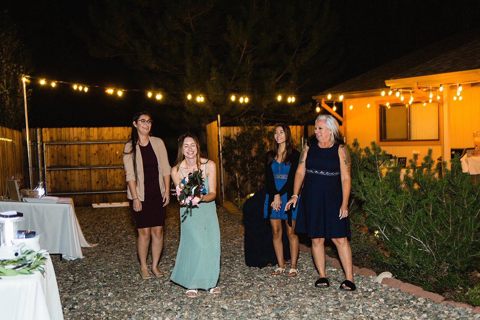 Bouquet toss at backyard wedding reception by Flagstaff wedding photographer PMA Photography.