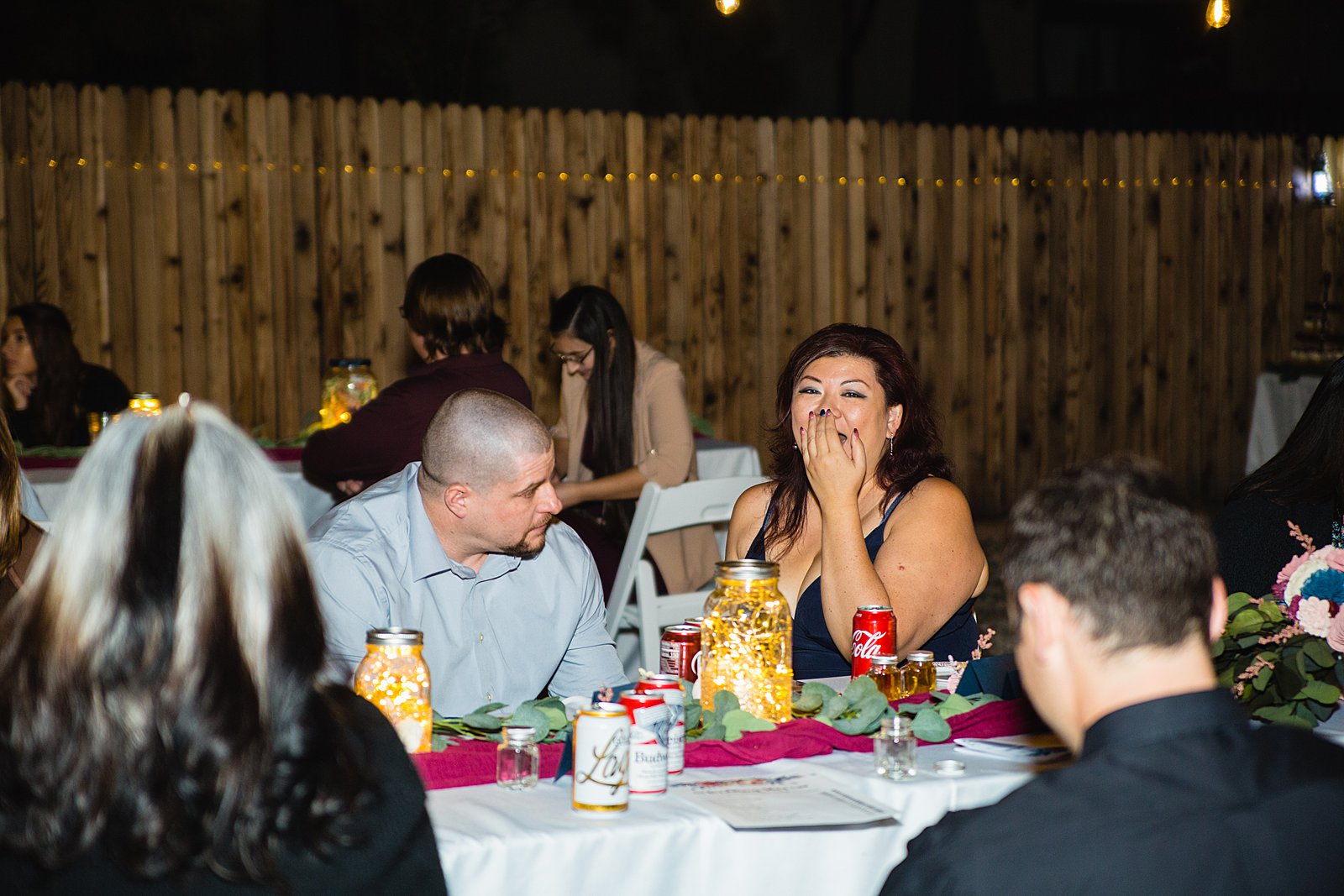 Guests laughing during intimate dinner wedding reception by PMA Photography.