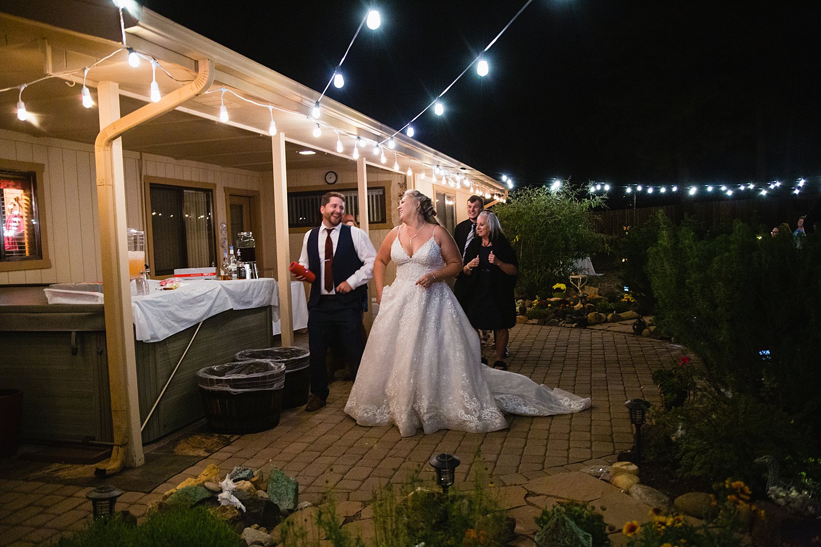 Bride and Groom dancing with guests at their backyard wedding reception by Arizona wedding photographer PMA Photography
