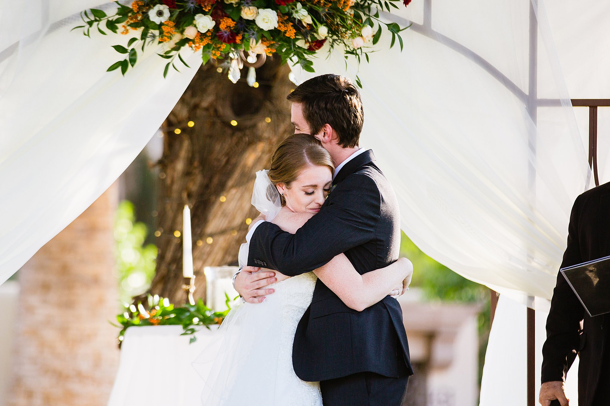 Bride and groom share a hug after their first kiss by PMA photography.