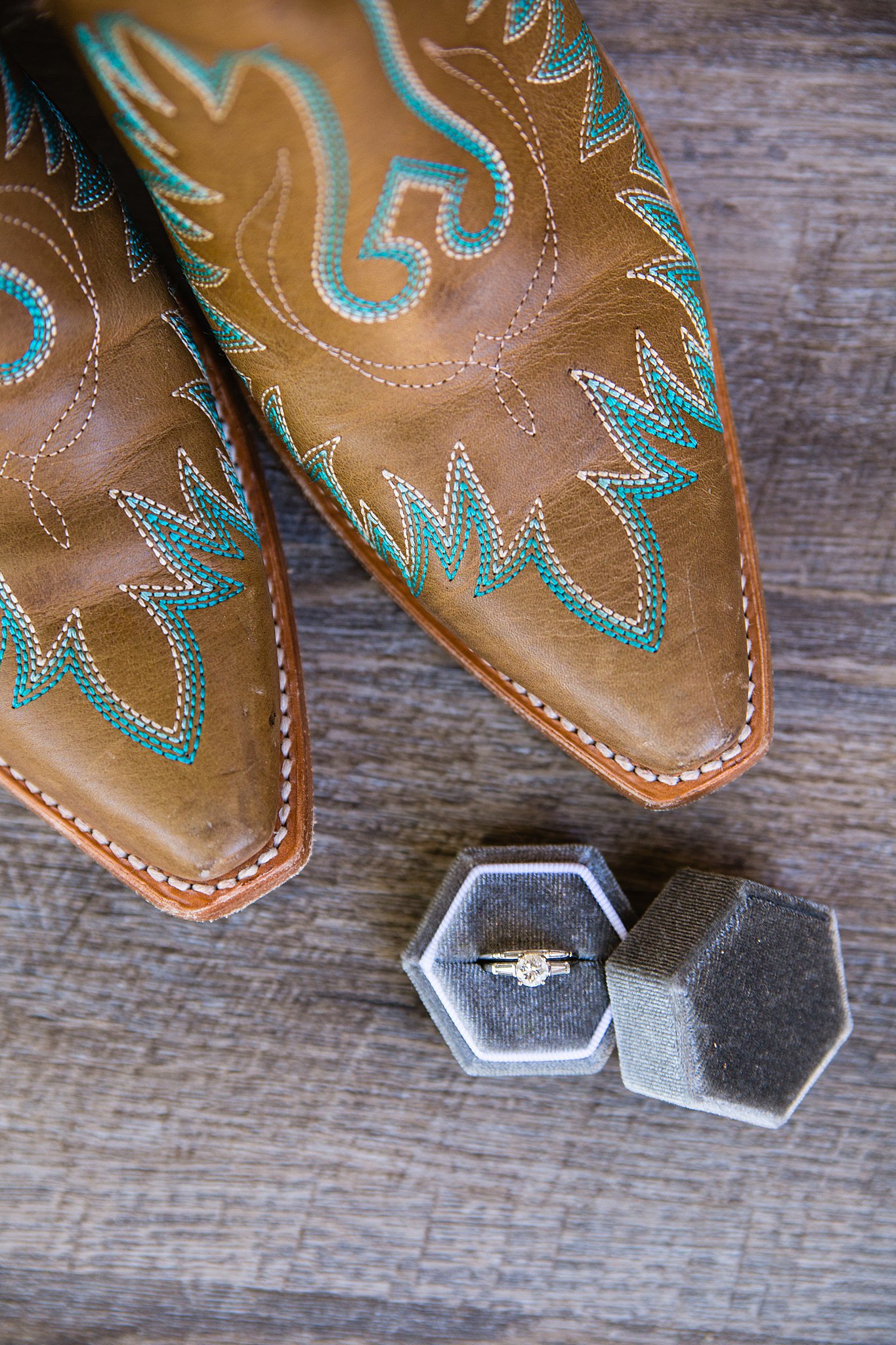 Bride's wedding boots with blue stitching and her simple white gold wedding ring by PMA Photography.