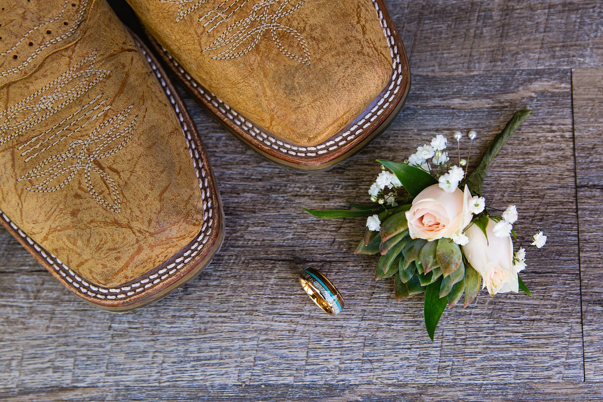 Groom's wedding boots, custom wedding ring with antler, turquoise, and wood with a succulent and rose boutonniere by Arizona wedding photographer PMA Photography.