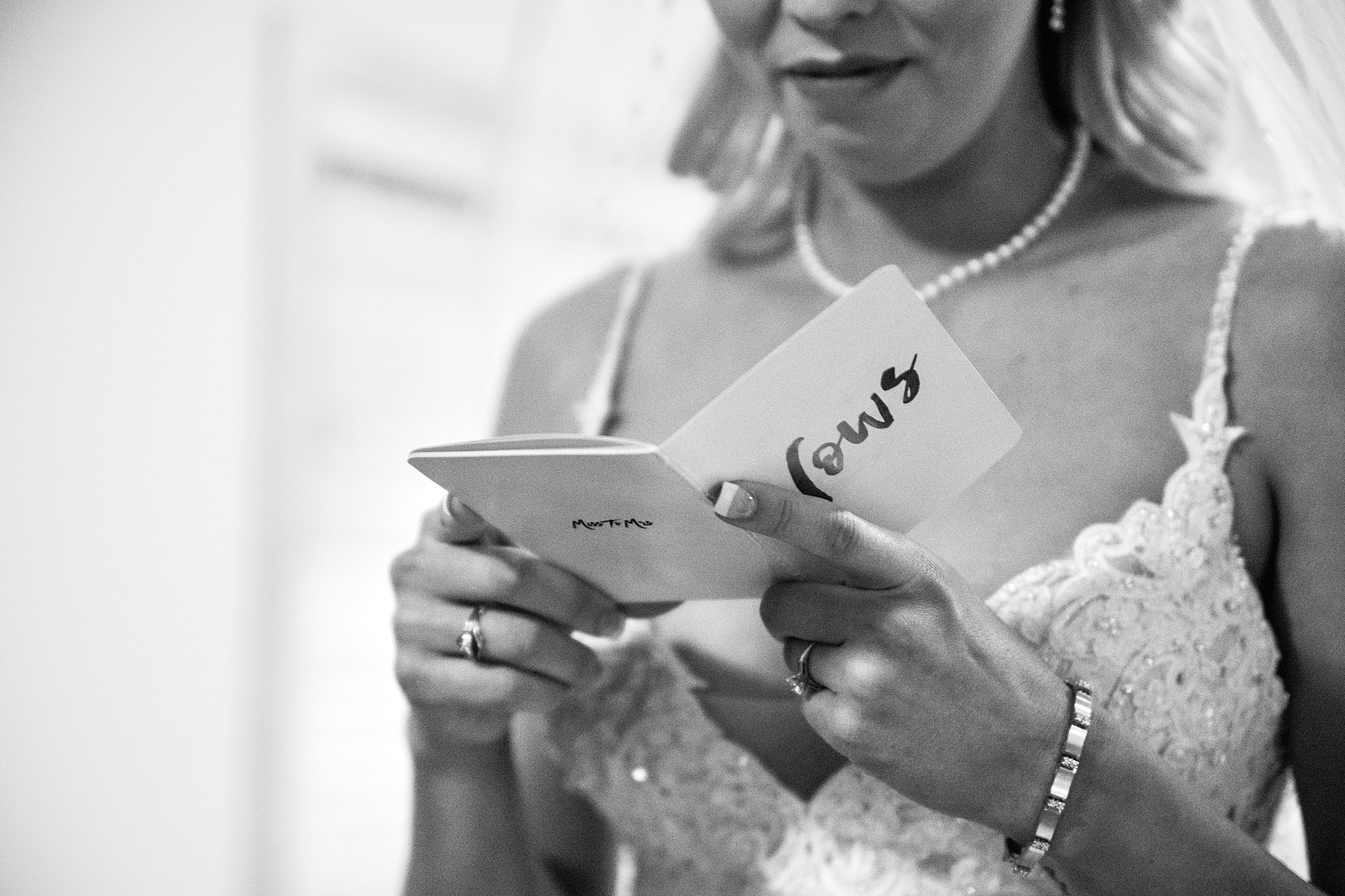 Bride reading person vows from her husband before their wedding ceremony by Arizona wedding photographer PMA Photography