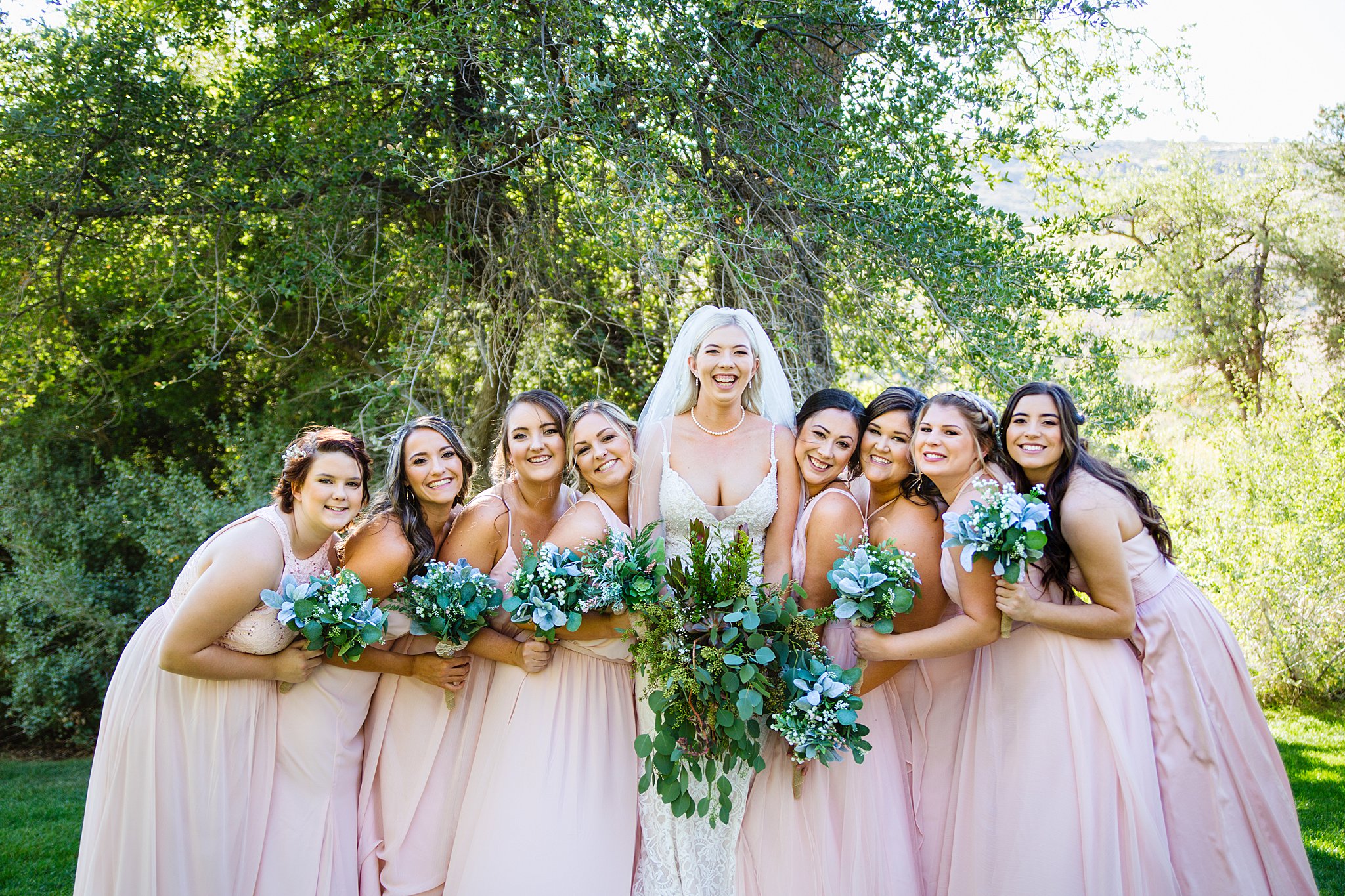 Bride and bridesmaids laughing together at Van Dickson Ranch wedding by Skull Valley wedding photographer PMA Photography.