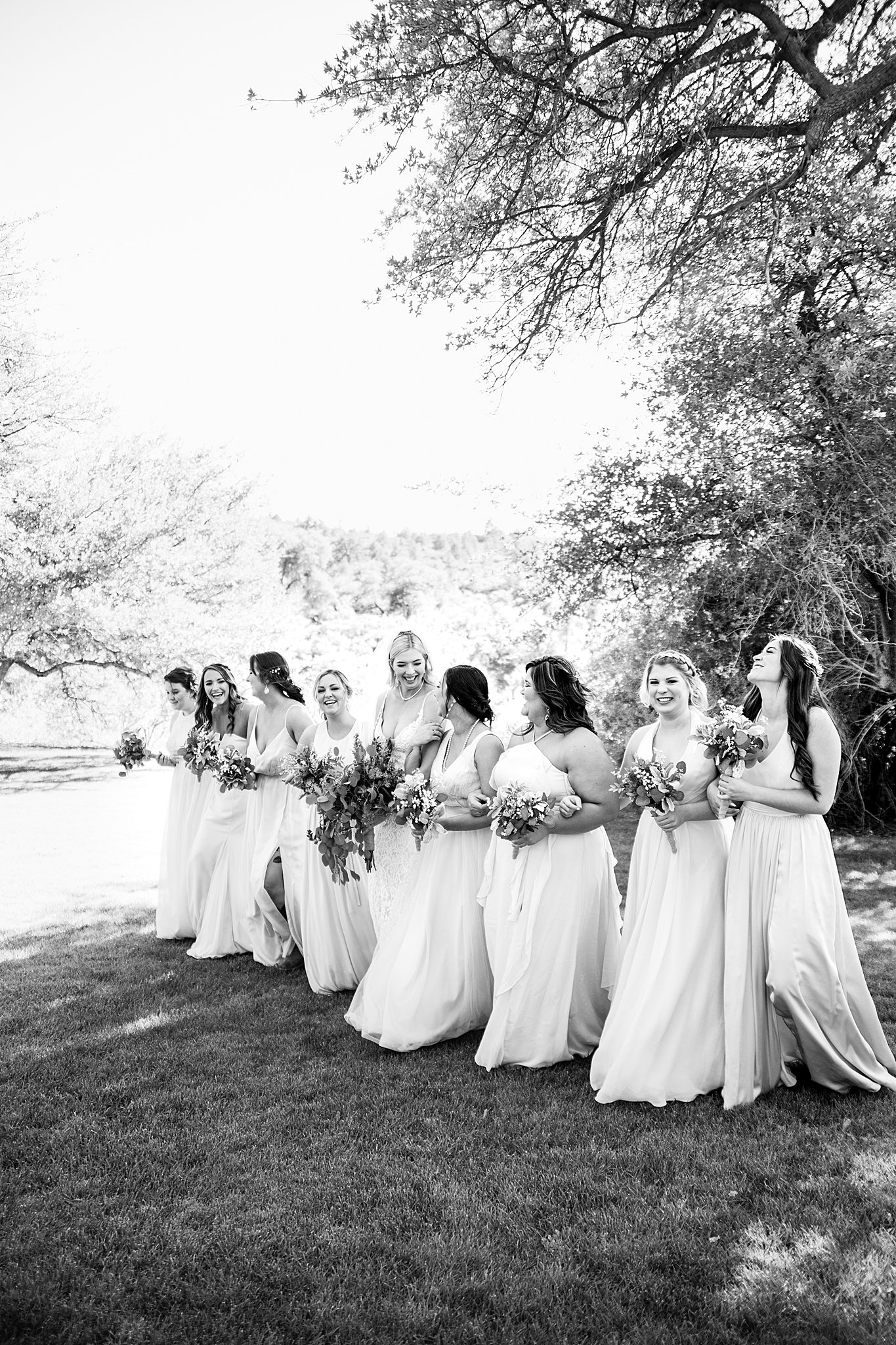 Bride and bridesmaids laughing together at Van Dickson Ranch wedding by Skull Valley wedding photographer PMA Photography.
