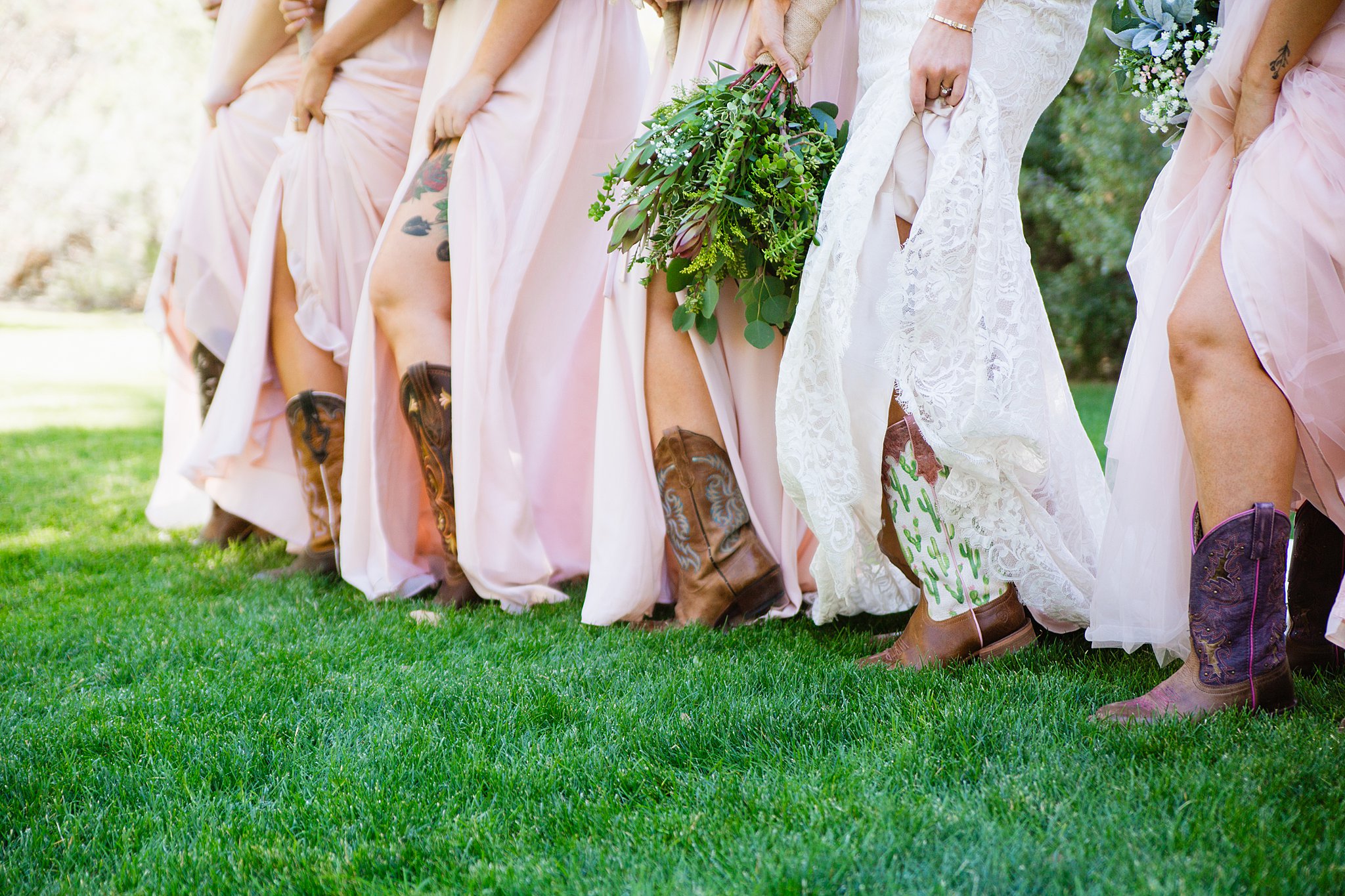 Bridesmaids and bride show off their boots under their wedding dresses for a Van Dickson Ranch wedding by PMA Photography.