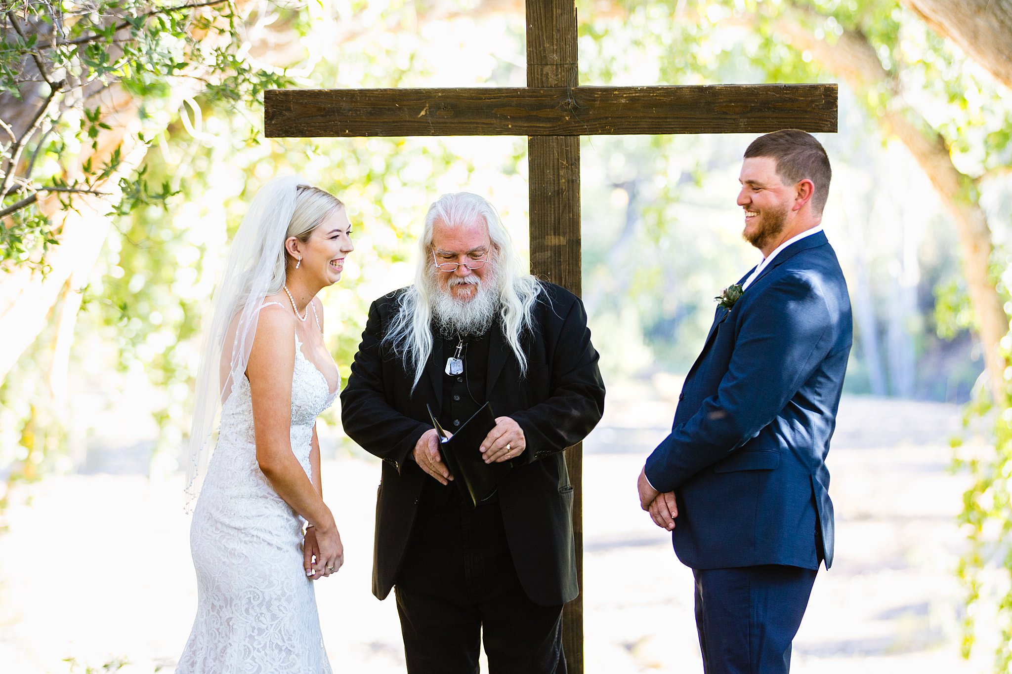 Bride and Groom laughing together during Van Dickson Ranch wedding ceremony by Skull Valley wedding photographer PMA Photography.