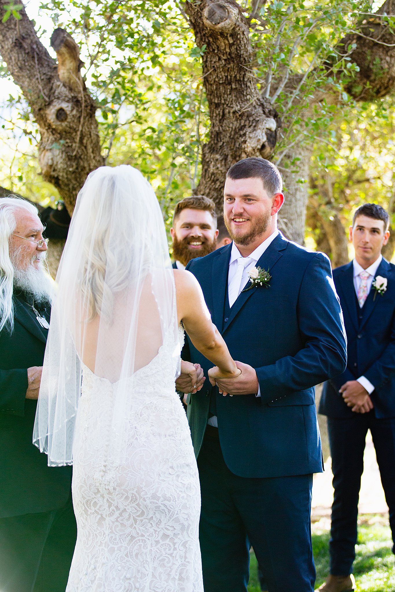 Groom looking at his bride during their wedding ceremony at Van Dickson Ranch by Skull Valley wedding photographer PMA Photography.