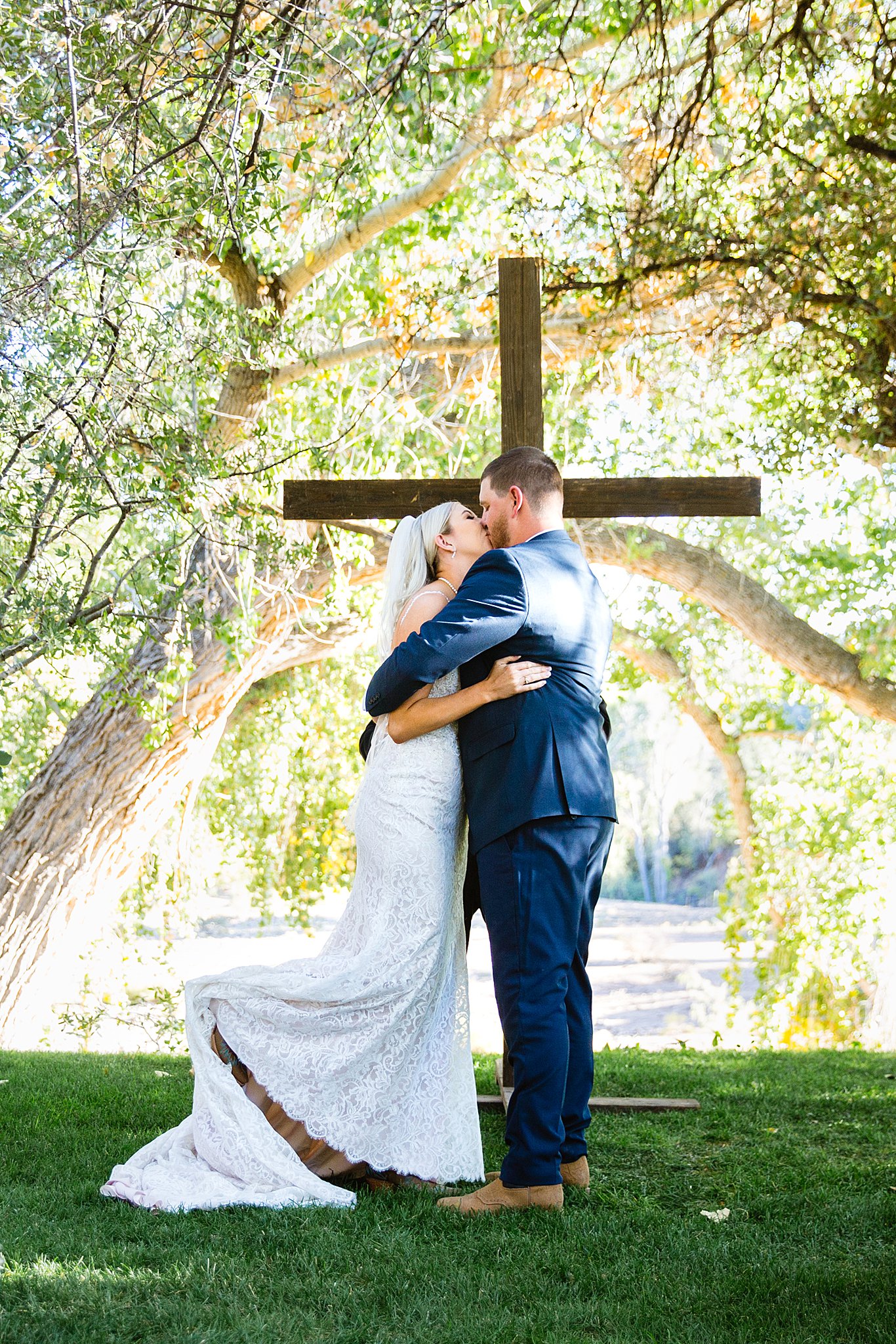 Bride and Groom share their first kiss during their wedding ceremony at Van Dickson Ranch by Arizona wedding photographer PMA Photography.