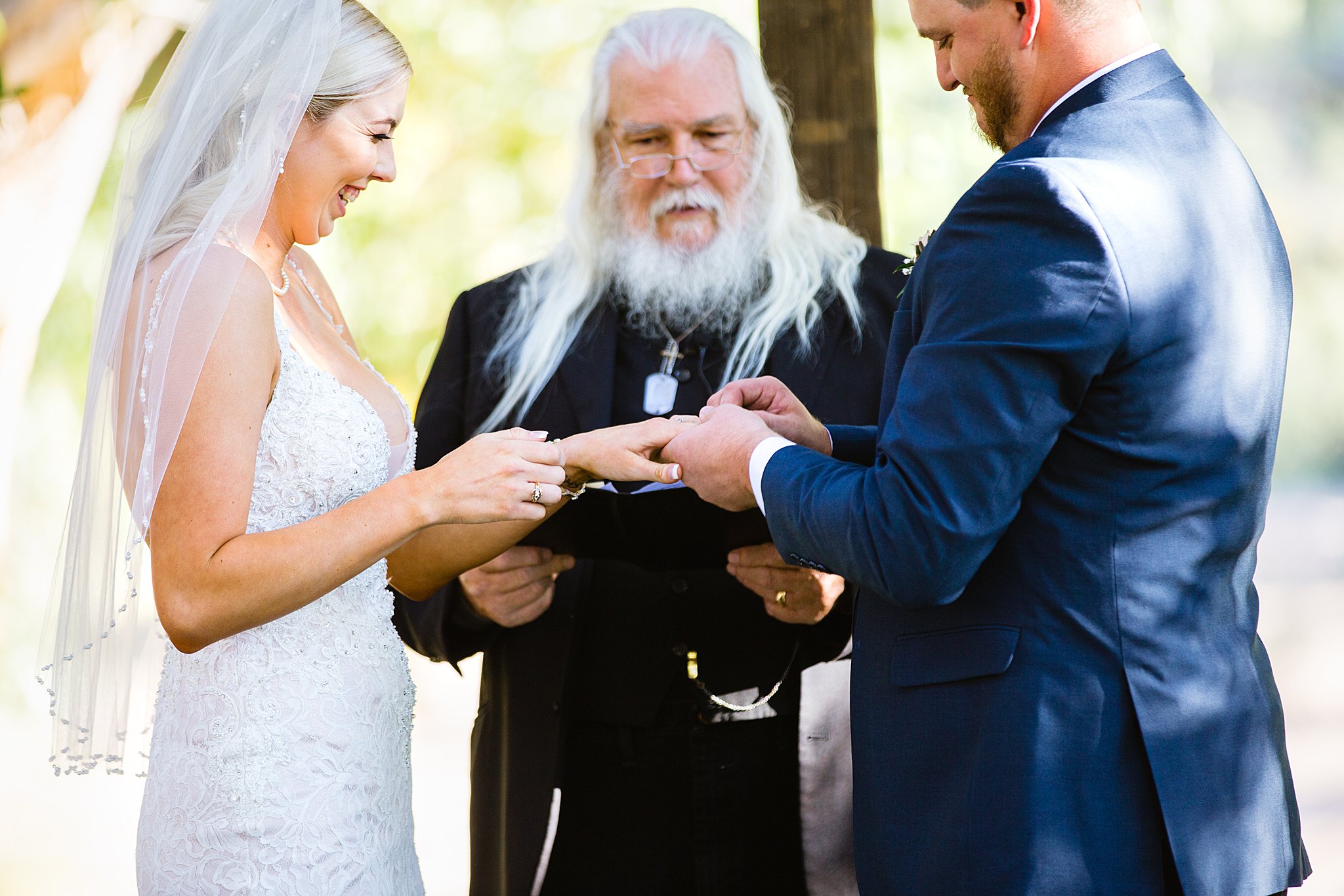 Bride and Groom exchange rings during their wedding ceremony at Van Dickson Ranch by Arizona wedding photographer PMA Photography.