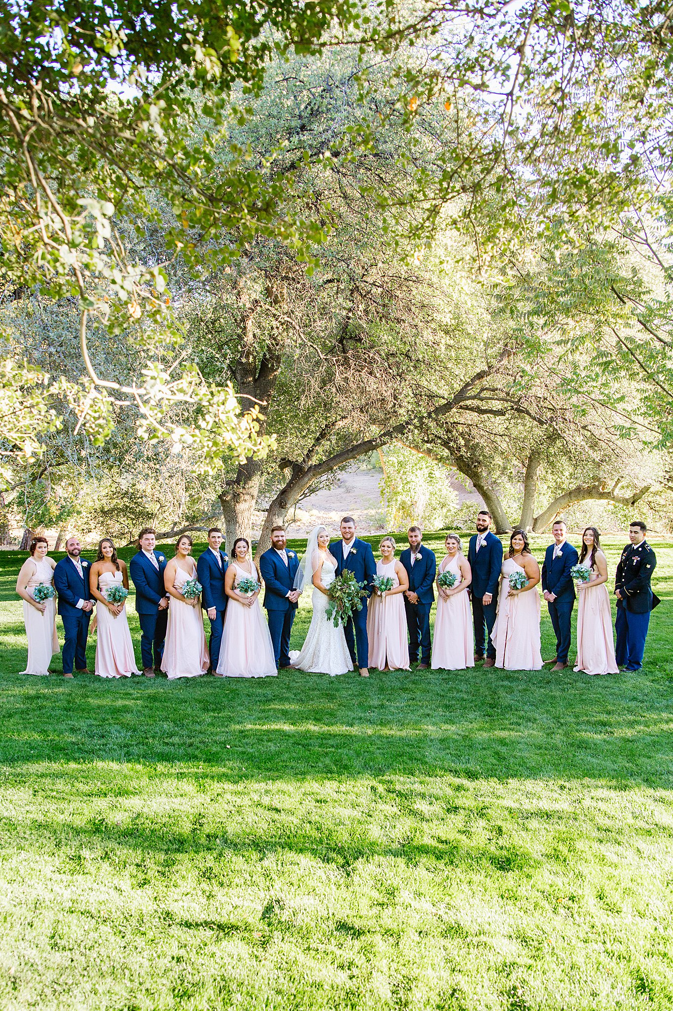 Bridal party together at a Van Dickson Ranch wedding by Arizona wedding photographer PMA Photography.