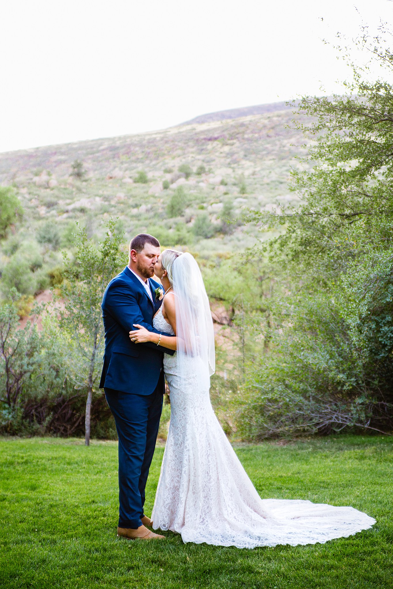 Bride and Groom share a kiss during their Van Dickson Ranch wedding by Skull Valley wedding photographer PMA Photography.