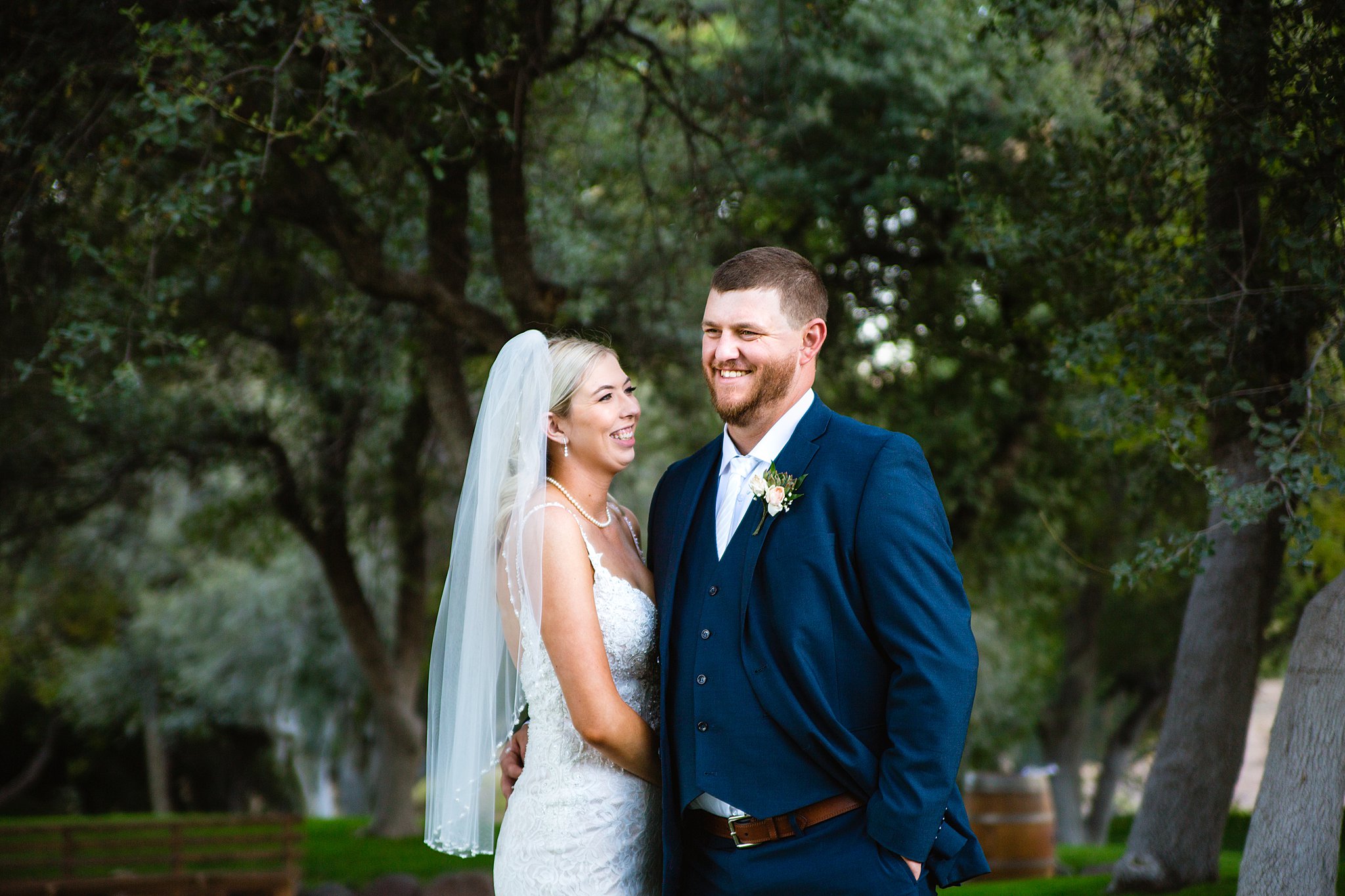 Bride and Groom laughing together during their Van Dickson Ranch wedding by Arizona wedding photographer PMA Photography.