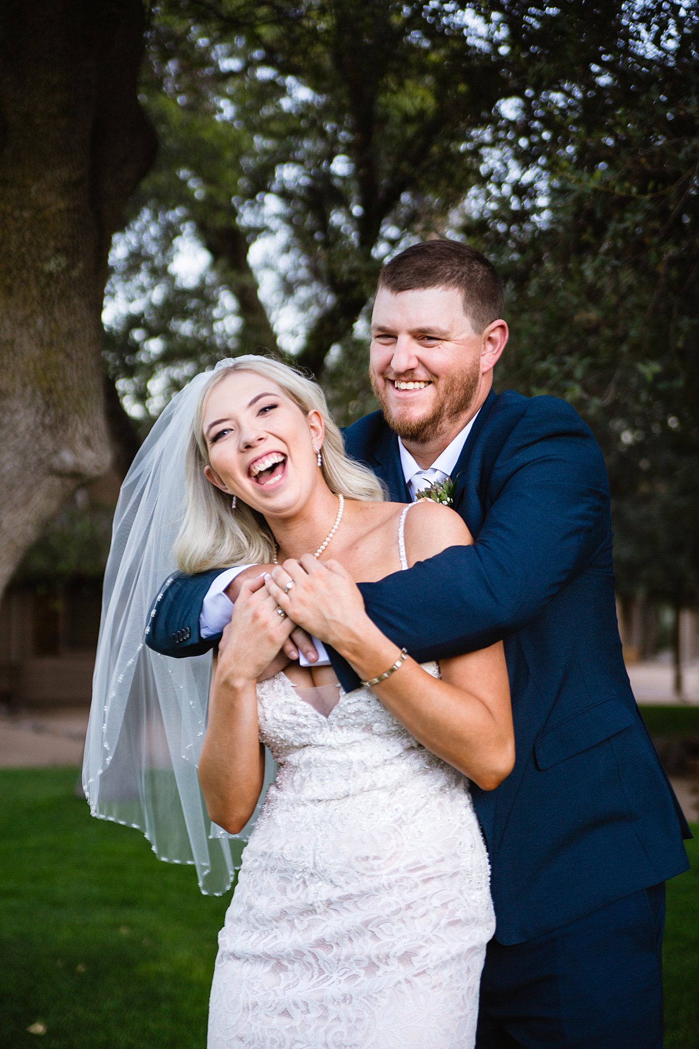 Bride and Groom laughing together during their Van Dickson Ranch wedding by Arizona wedding photographer PMA Photography.