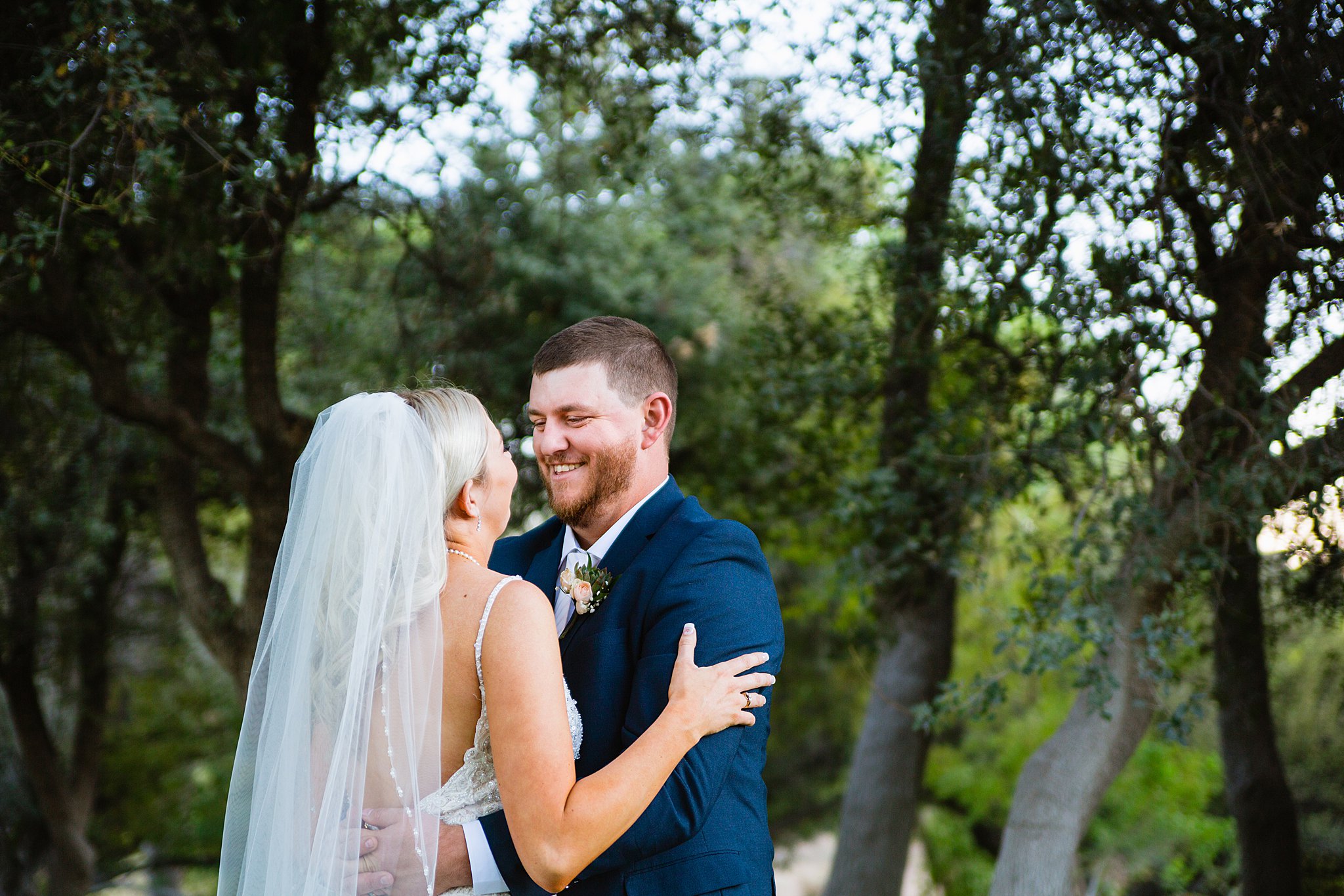 Bride and Groom laughing together during their Van Dickson Ranch wedding by Skull Valley wedding photographer PMA Photography.