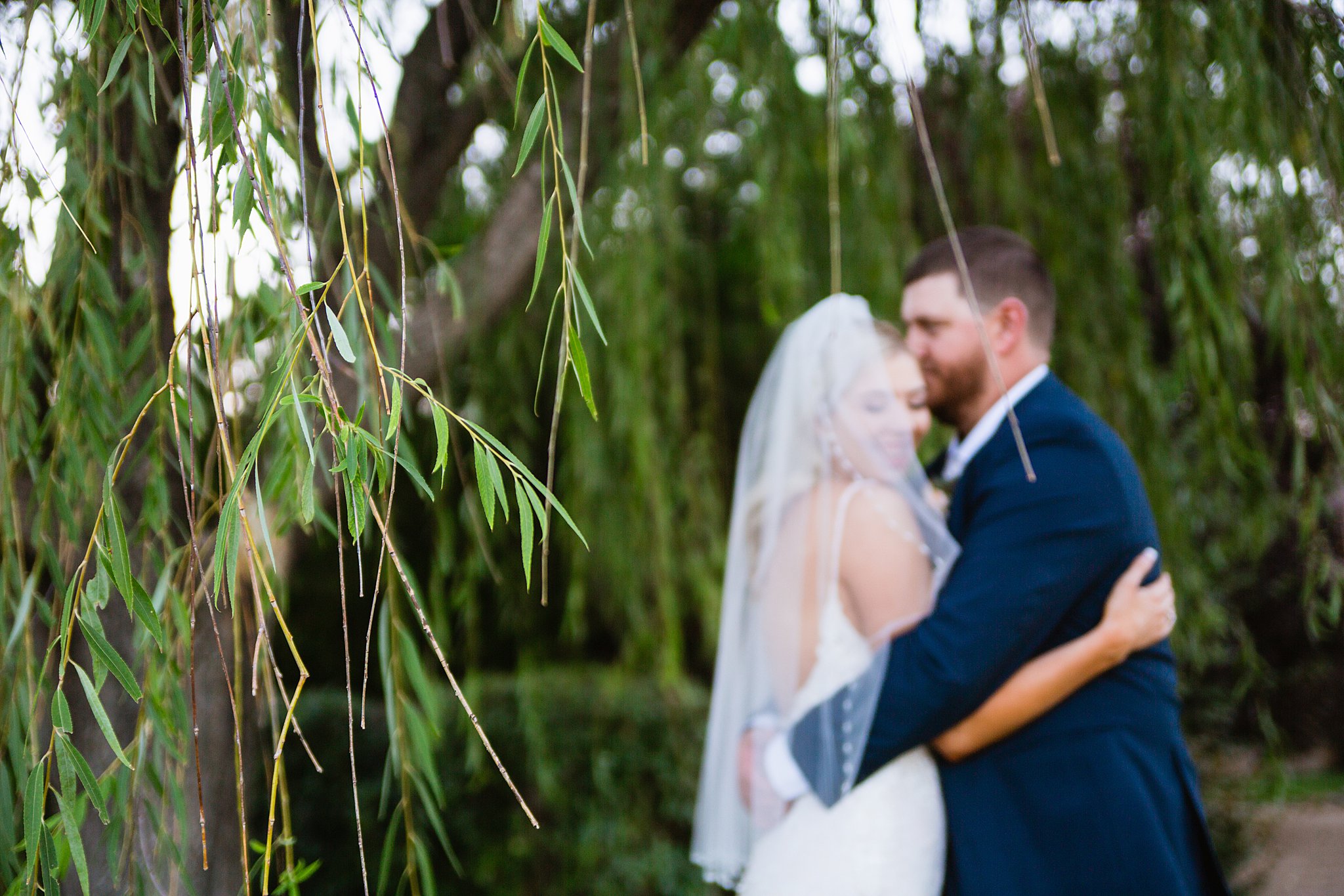 Bride and Groom share a kiss during their Van Dickson Ranch wedding by Skull Valley wedding photographer PMA Photography.