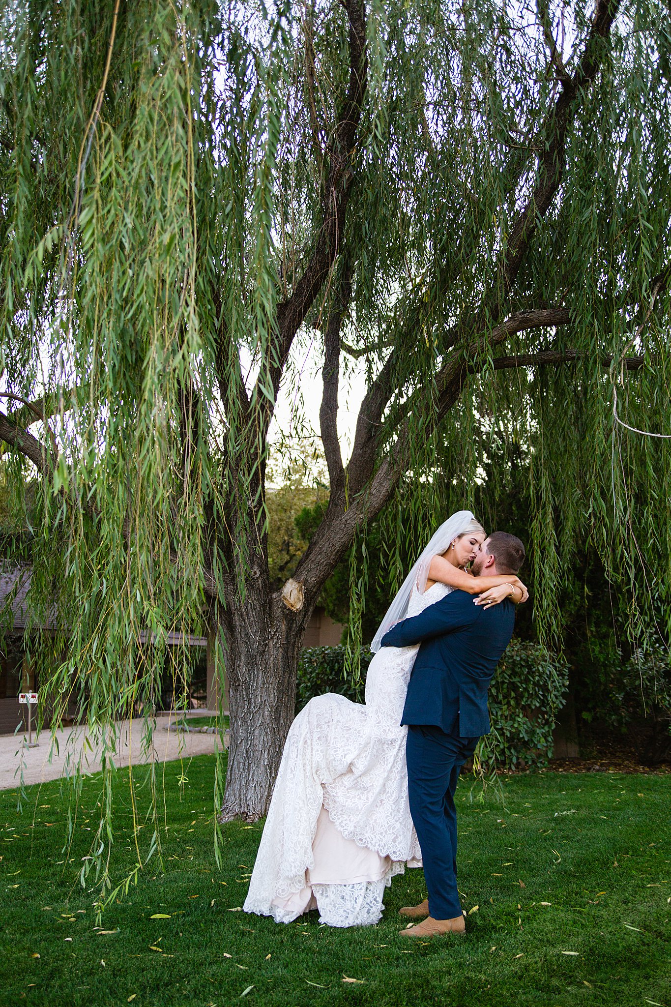 Bride and Groom share a kiss during their Van Dickson Ranch wedding by Arizona wedding photographer PMA Photography.