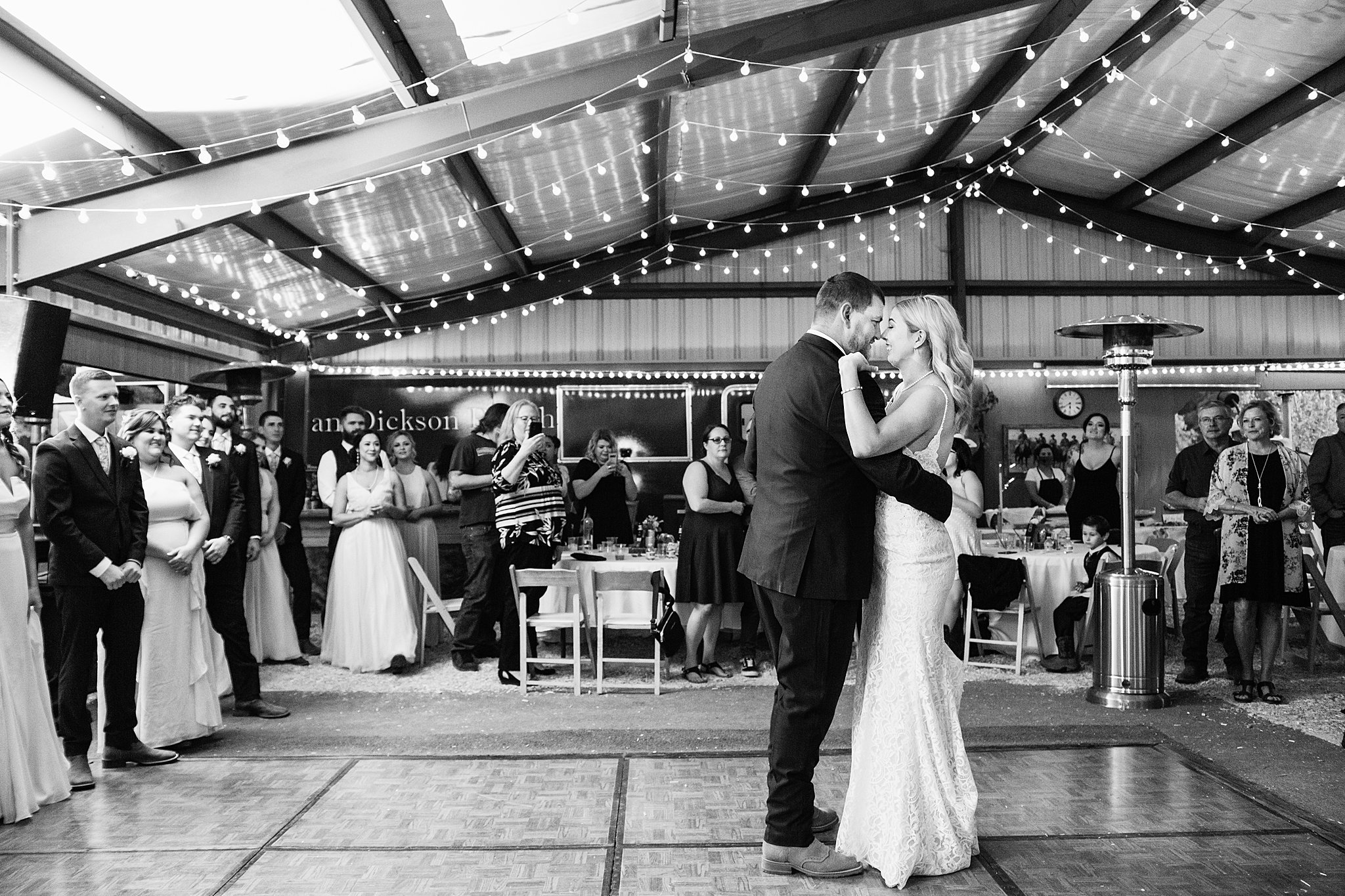 Bride and Groom sharing first dance at their Van Dickson Ranch wedding reception by Arizona wedding photographer PMA Photography.