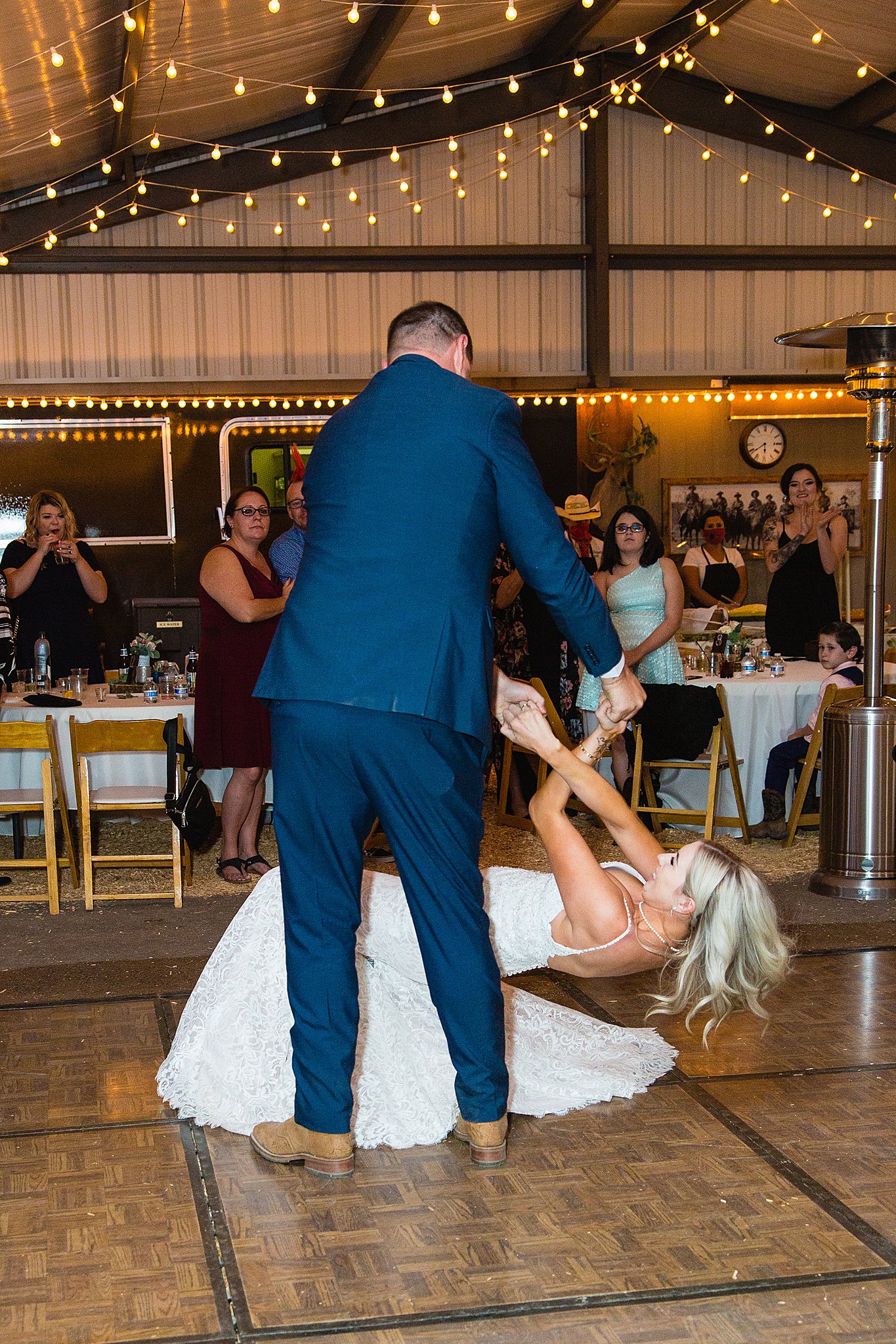 Bride and Groom sharing first dance at their Van Dickson Ranch wedding reception by Arizona wedding photographer PMA Photography.