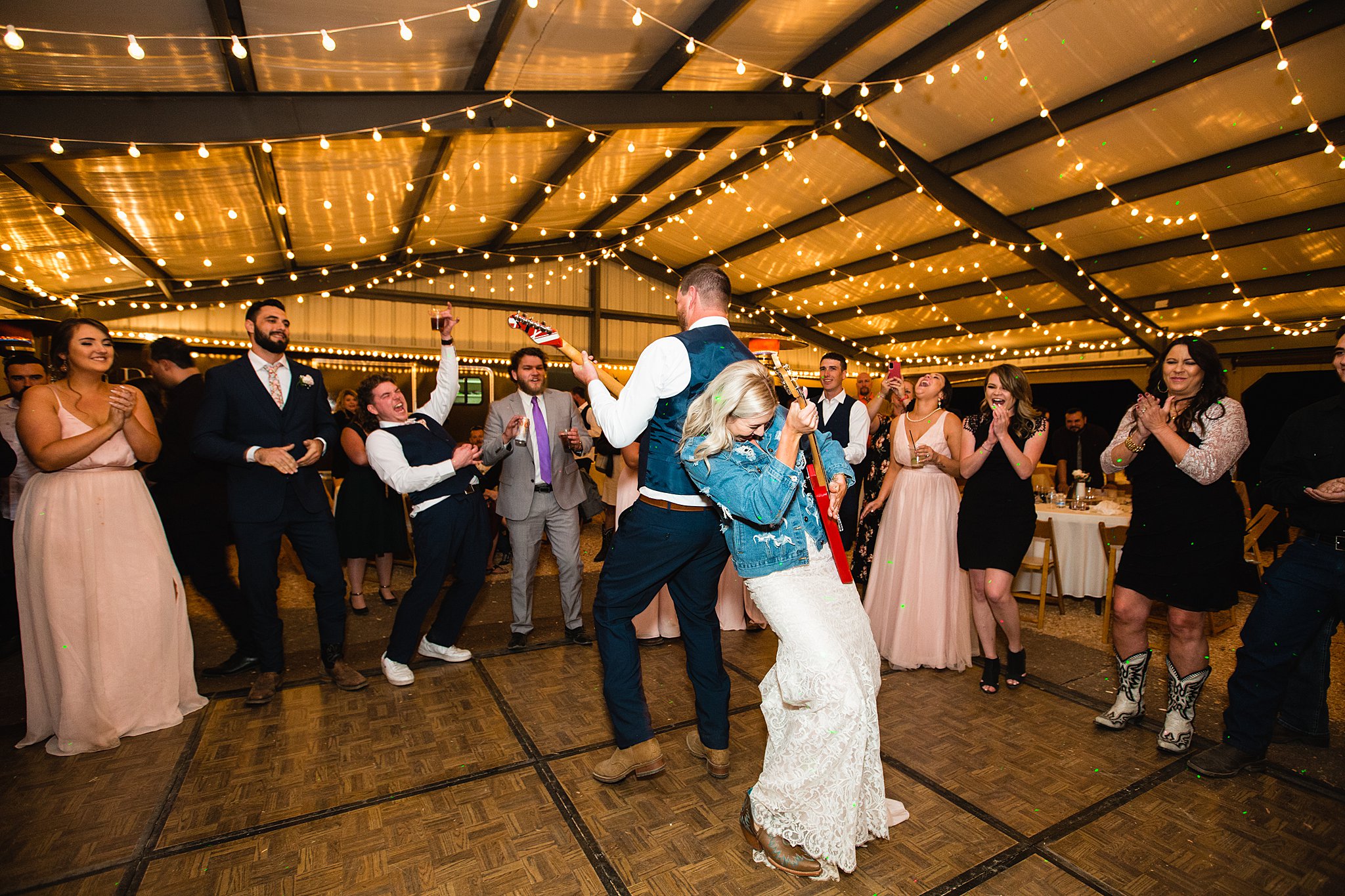 Bride and Groom dancing with guests at their Van Dickson Ranch wedding reception by Arizona wedding photographer PMA Photography