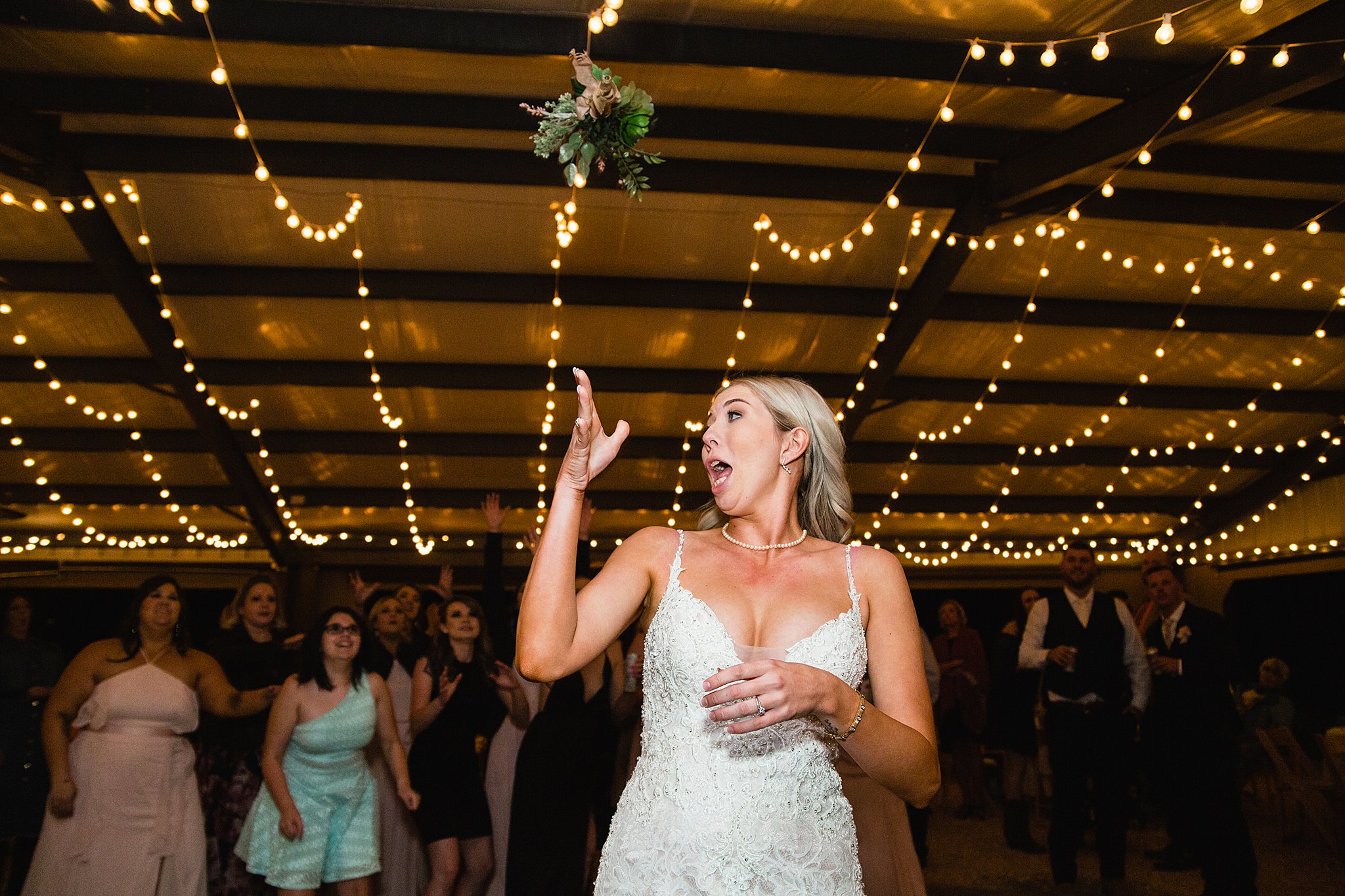 Bouquet toss at Van Dickson Ranch wedding reception by Skull Valley wedding photographer PMA Photography.