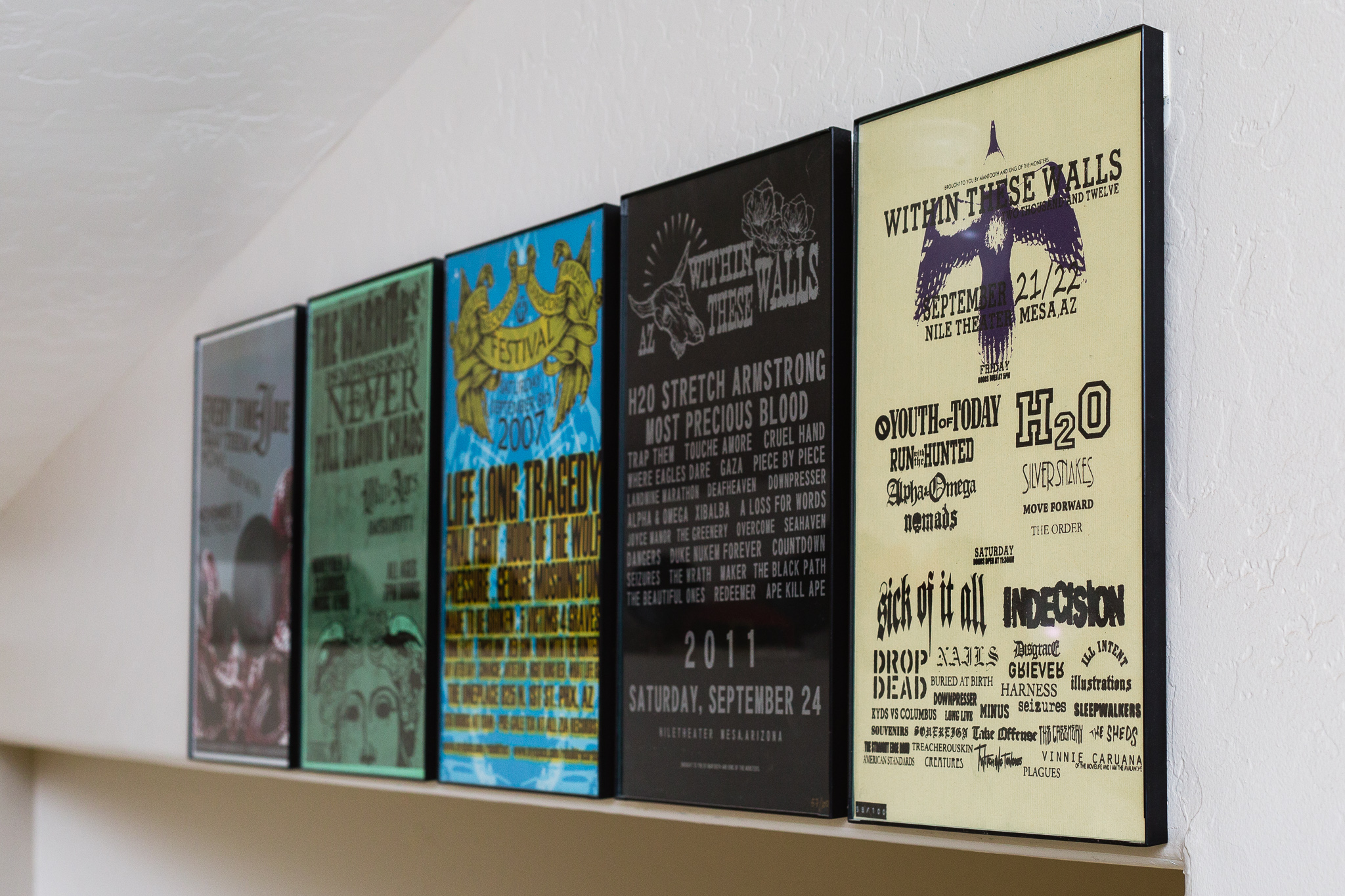 5 framed prints of concerts and festivals attended on date nights.