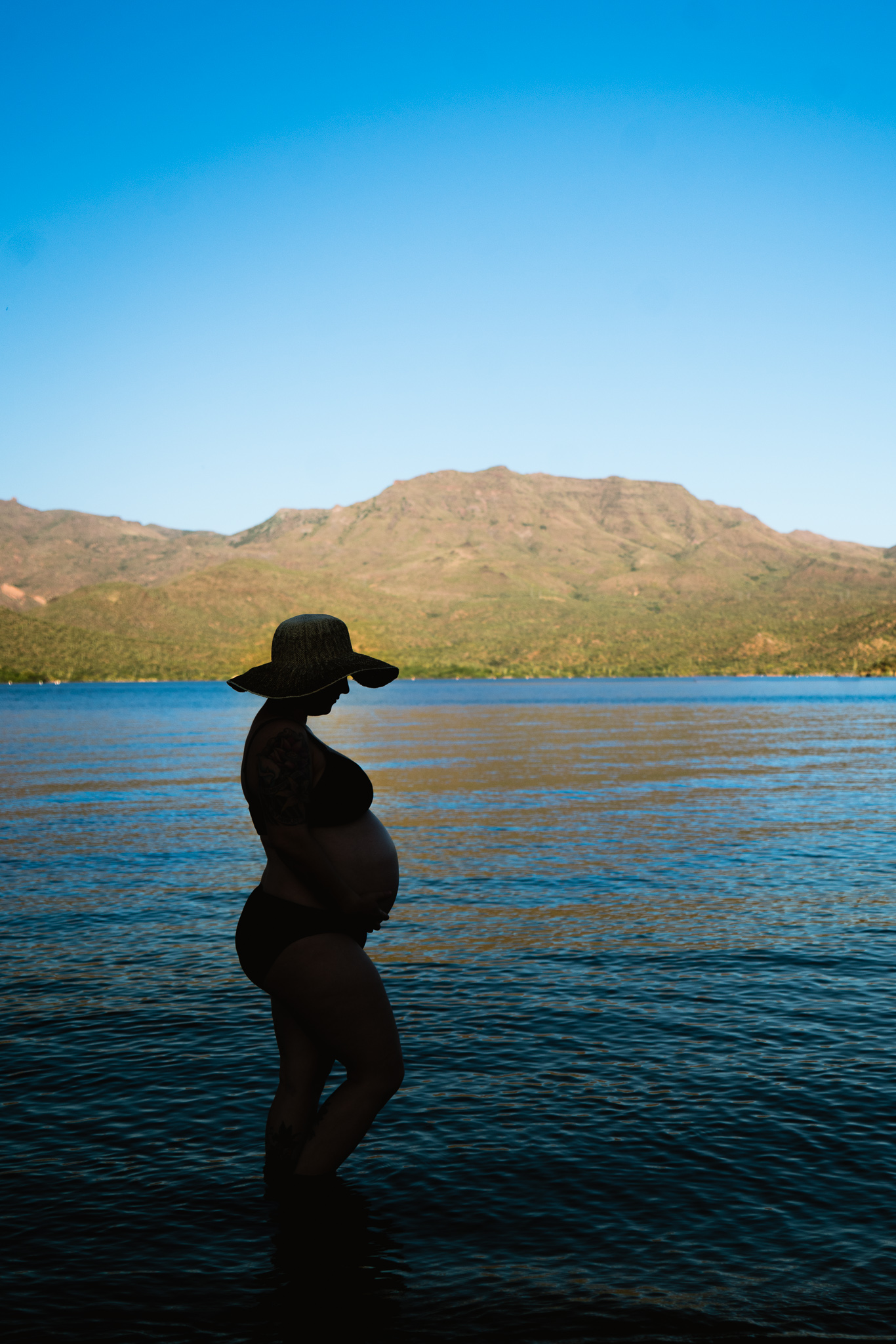 Silhouette of a baby bump at Bartlett Lake.