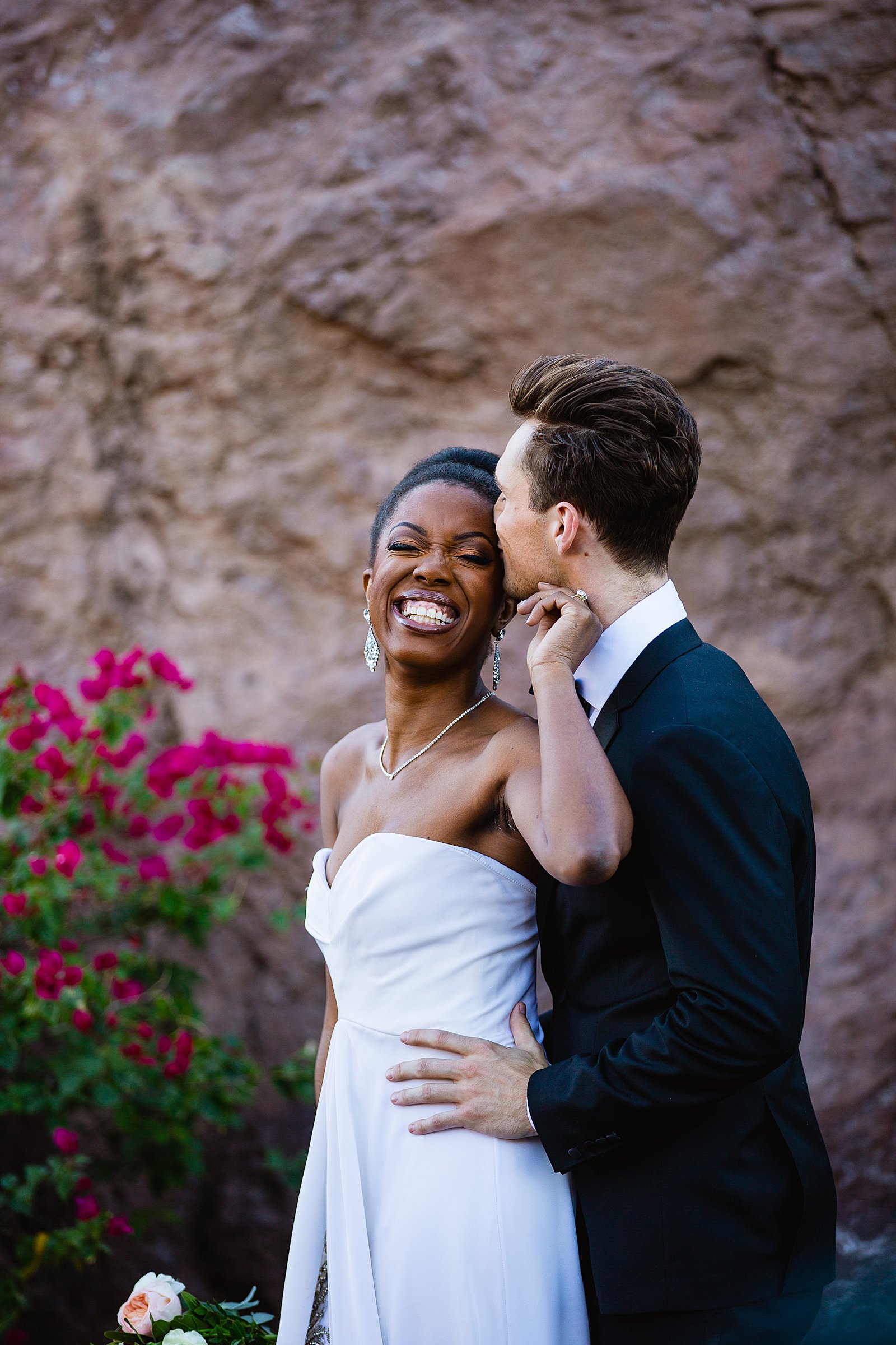 Bride and Groom laughing together during their multicultural wedding by Arizona wedding photographer PMA Photography.