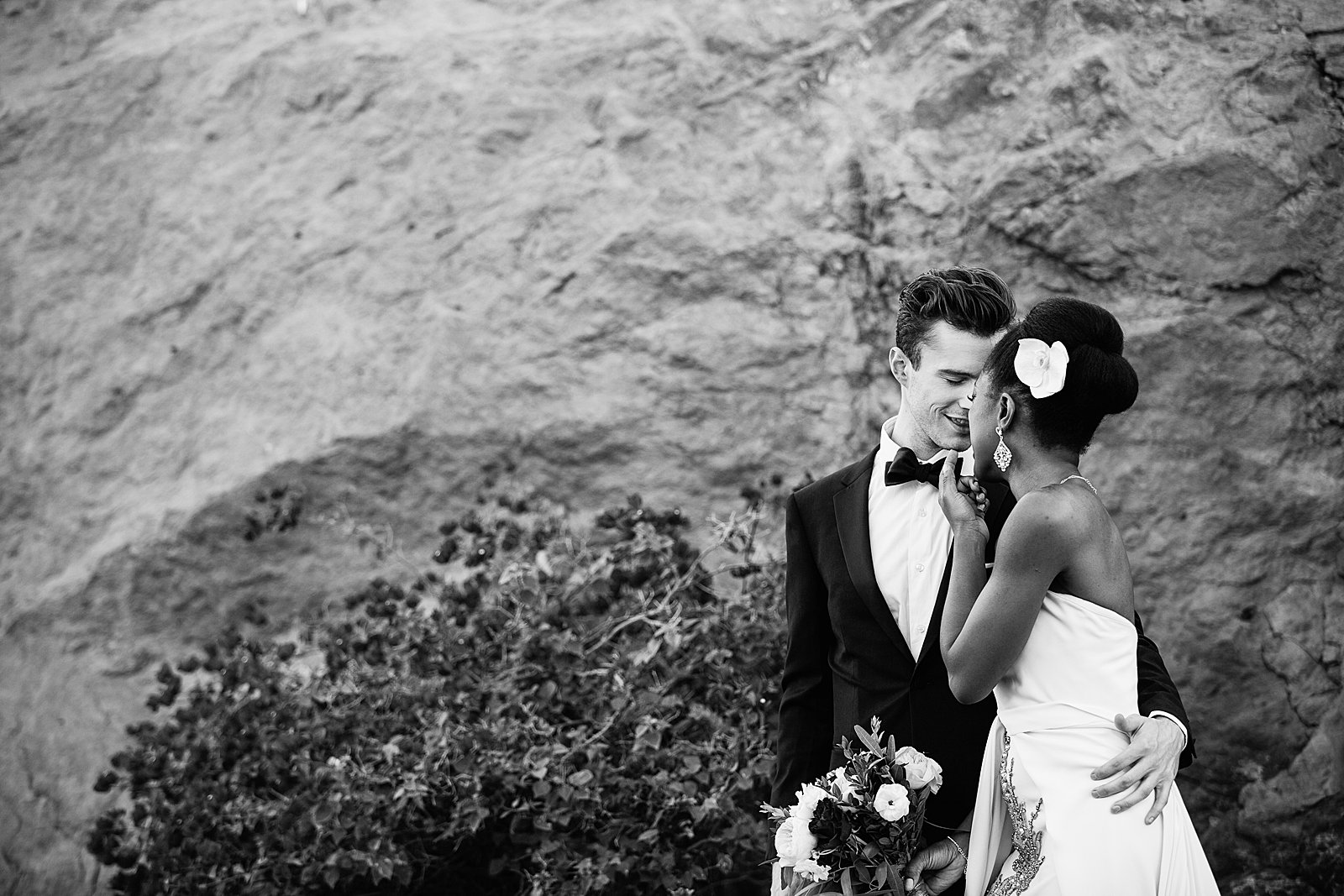Bride and Groom share a kiss during their multicultural wedding by Arizona wedding photographer PMA Photography.